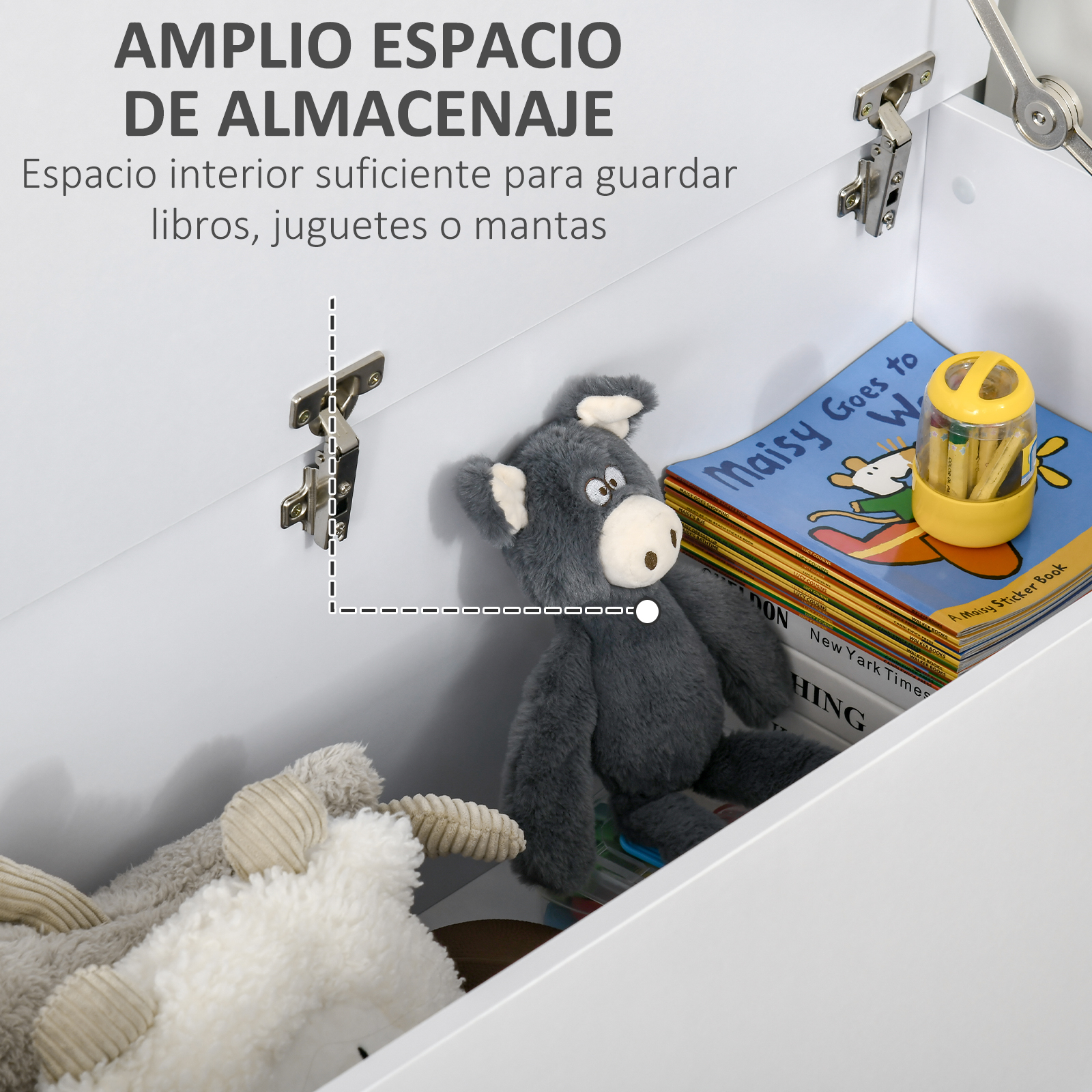 Un burro de peluche gris, un cordero blanco y una pila de libros en una caja blanca.