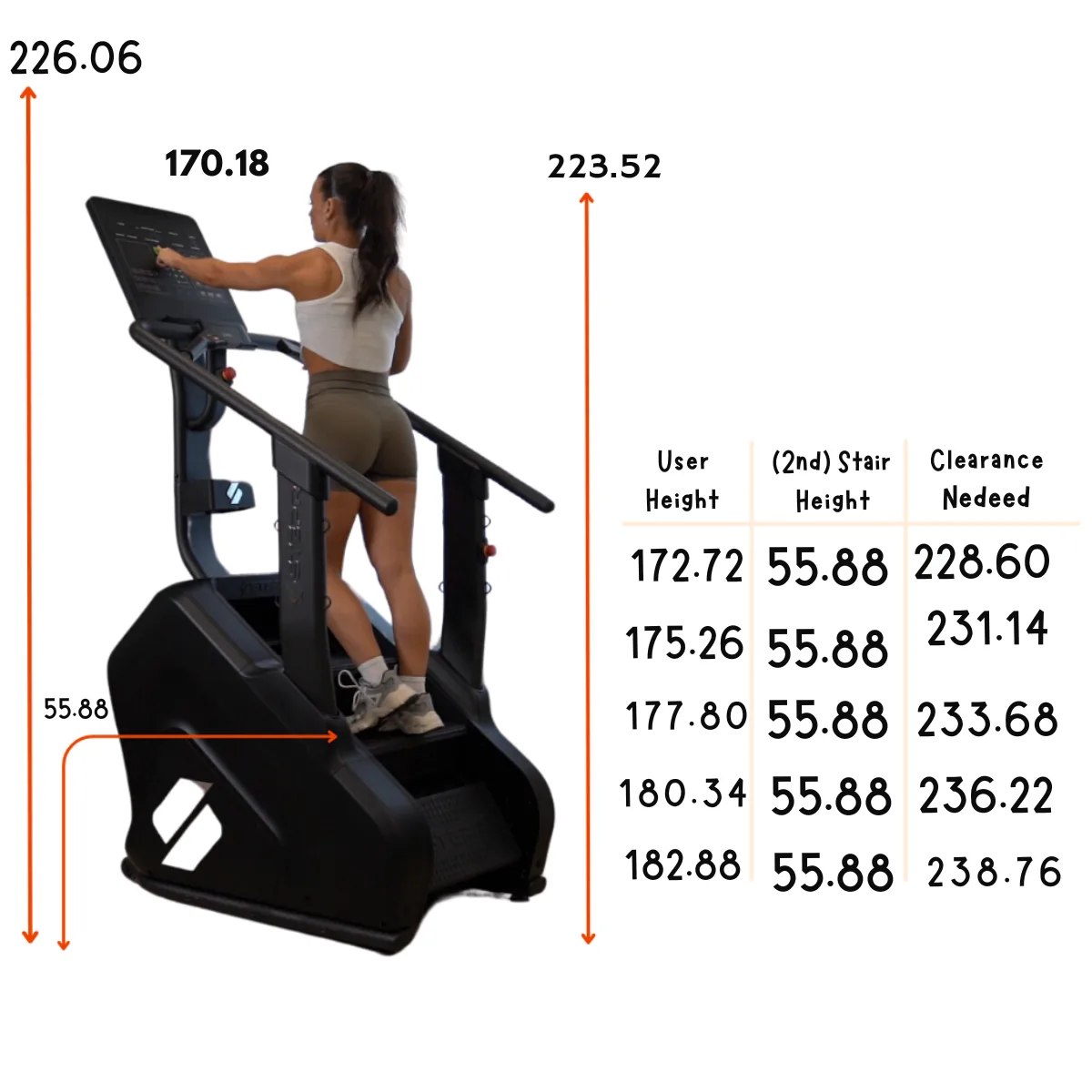A woman exercises on a black stair climber machine with dimensions and a table.