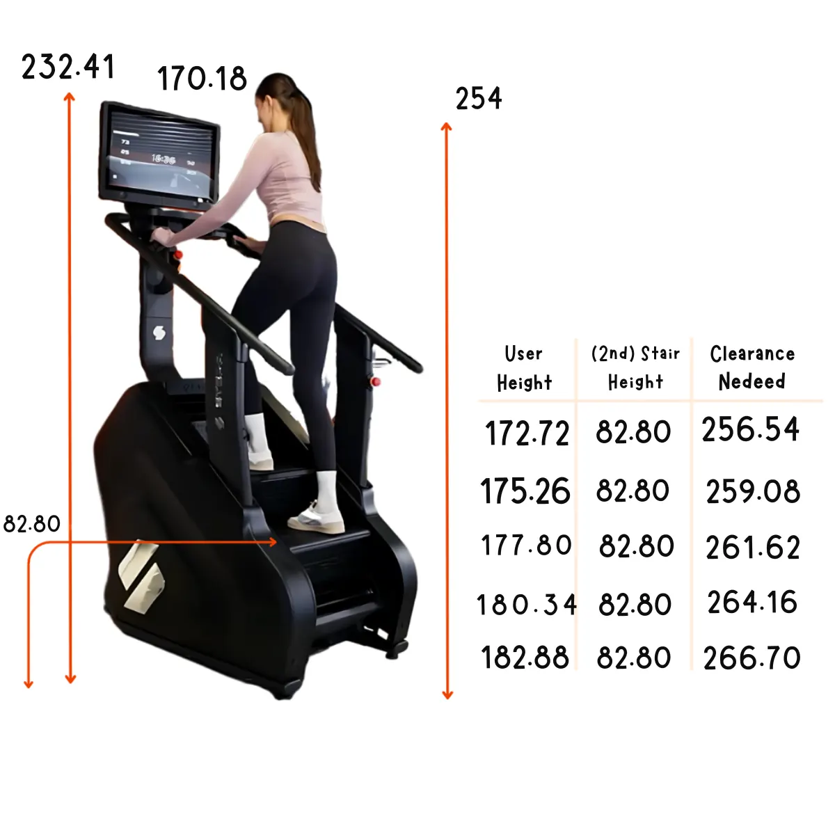 A woman exercises on a black stair climber with a screen. A table is next to it.
