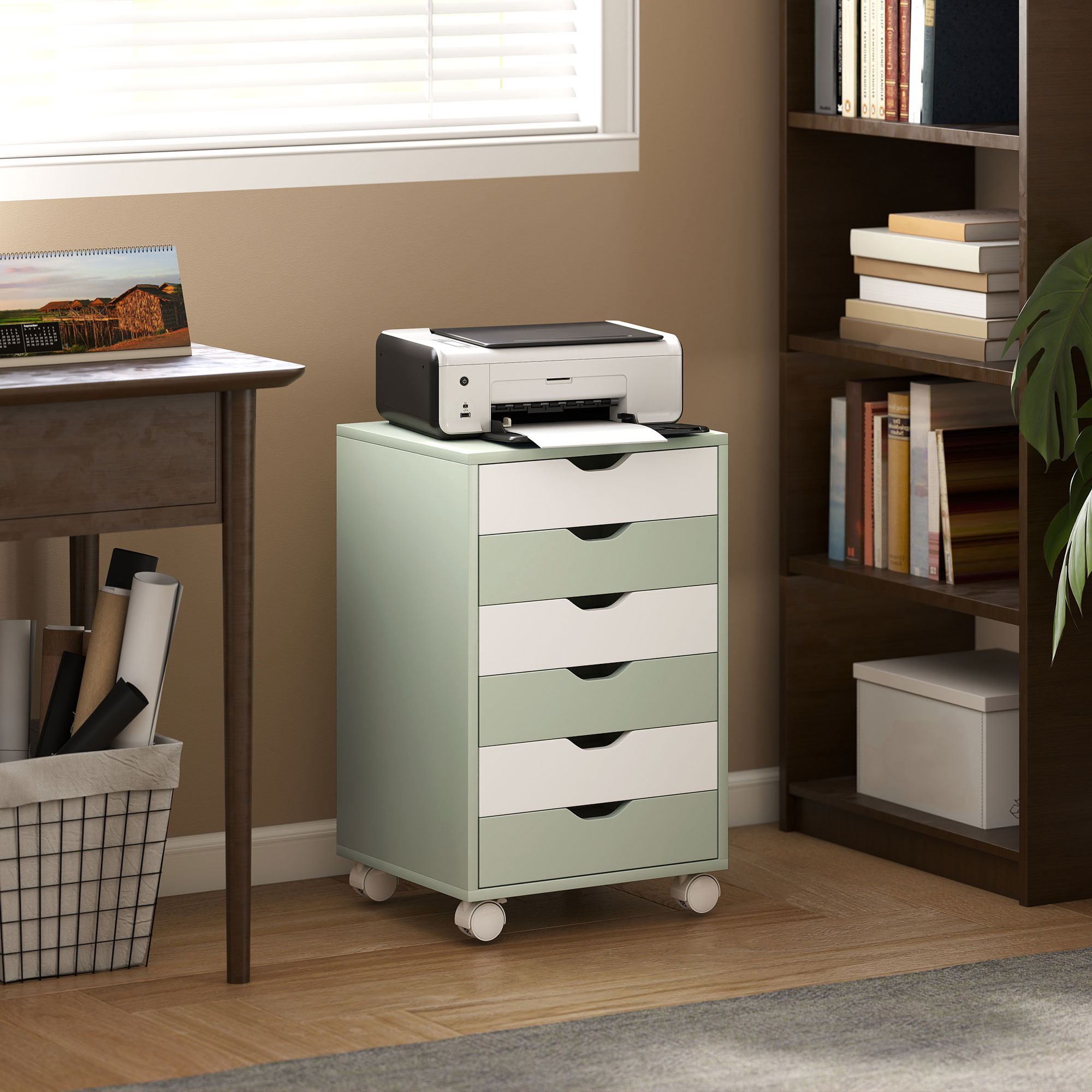 Una impresora sobre un carrito con ruedas verde menta junto a una estantería marrón.