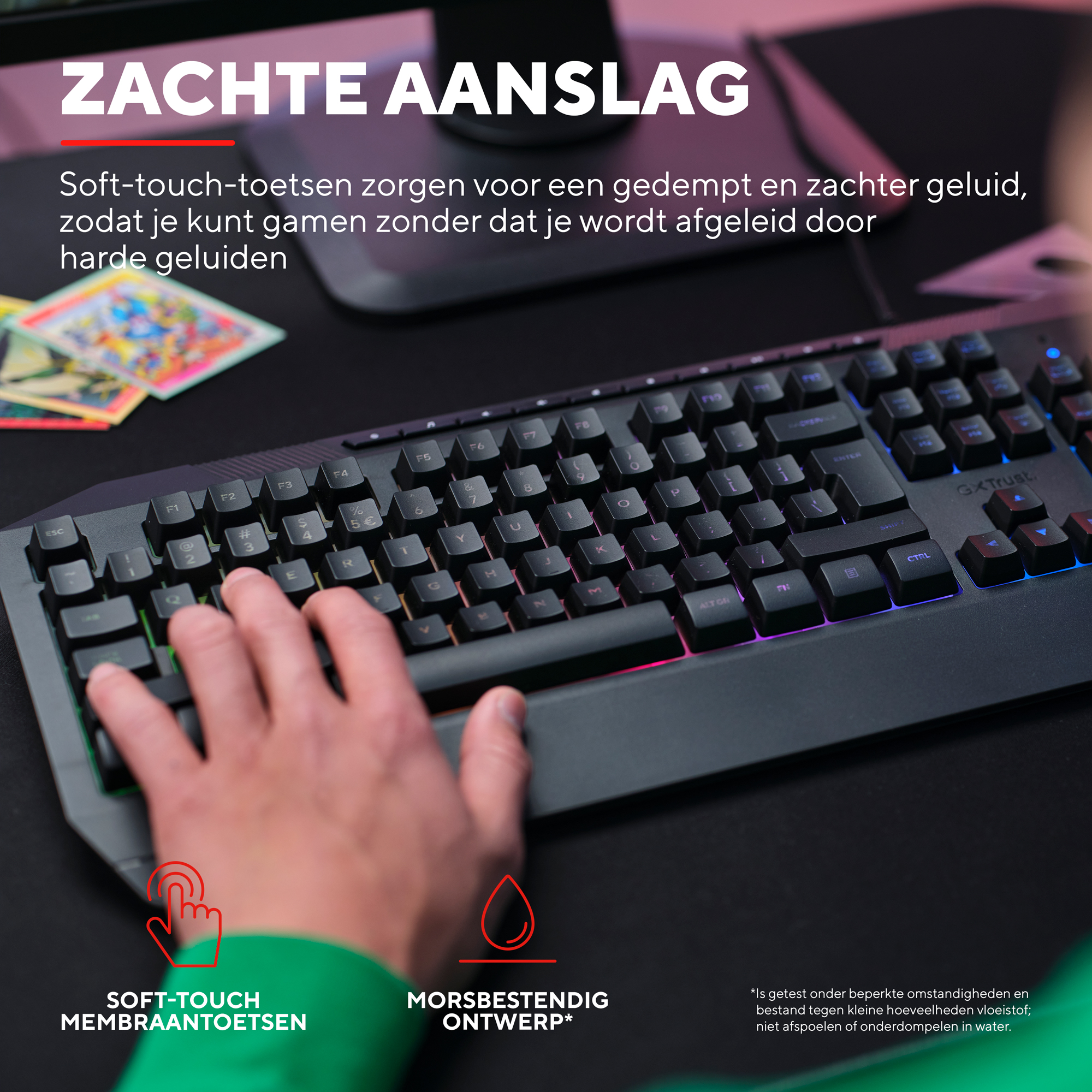 A hand uses a black keyboard with soft-touch keys. Colorful backlighting is visible.