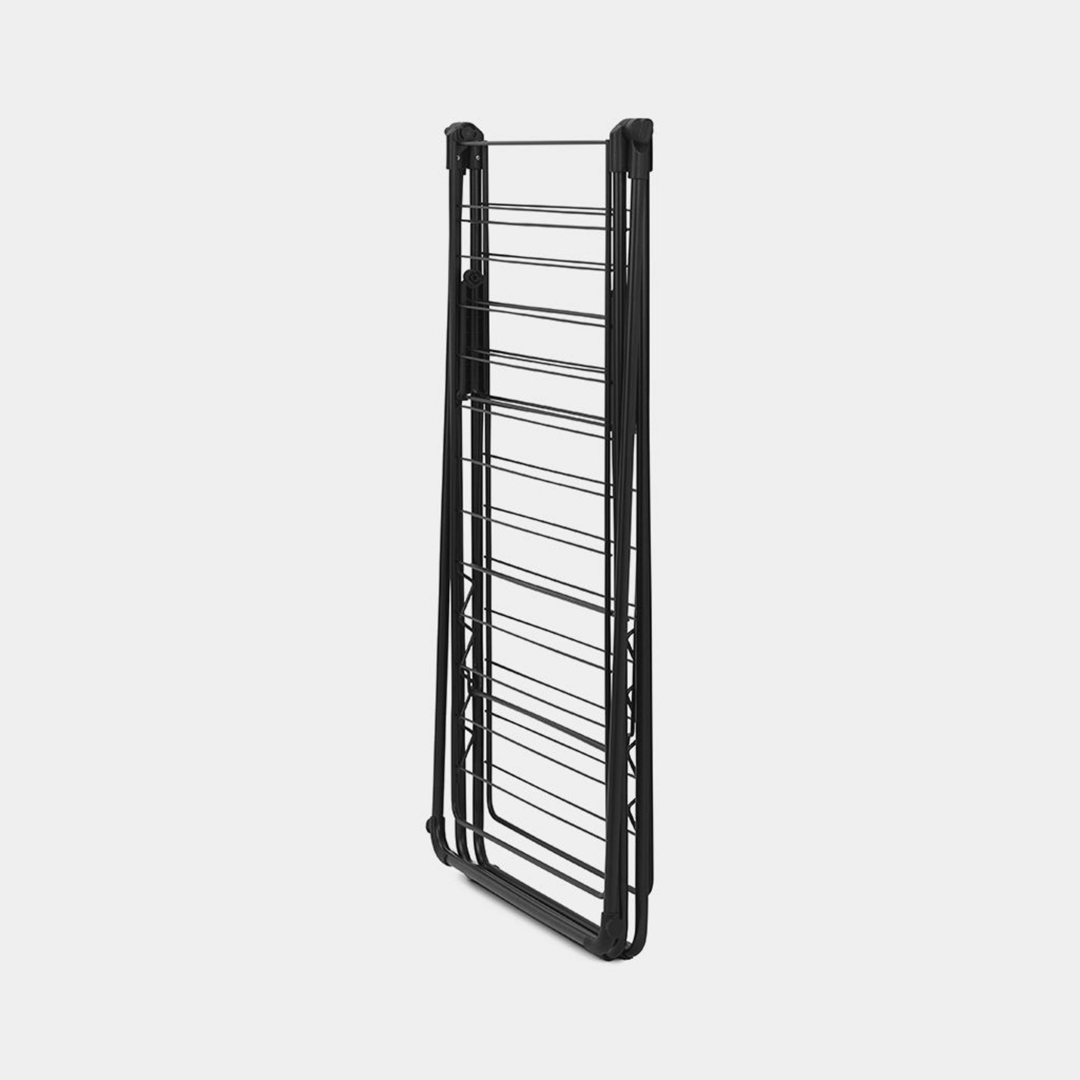 A folded black clothes drying rack with multiple rows of metal rods.
