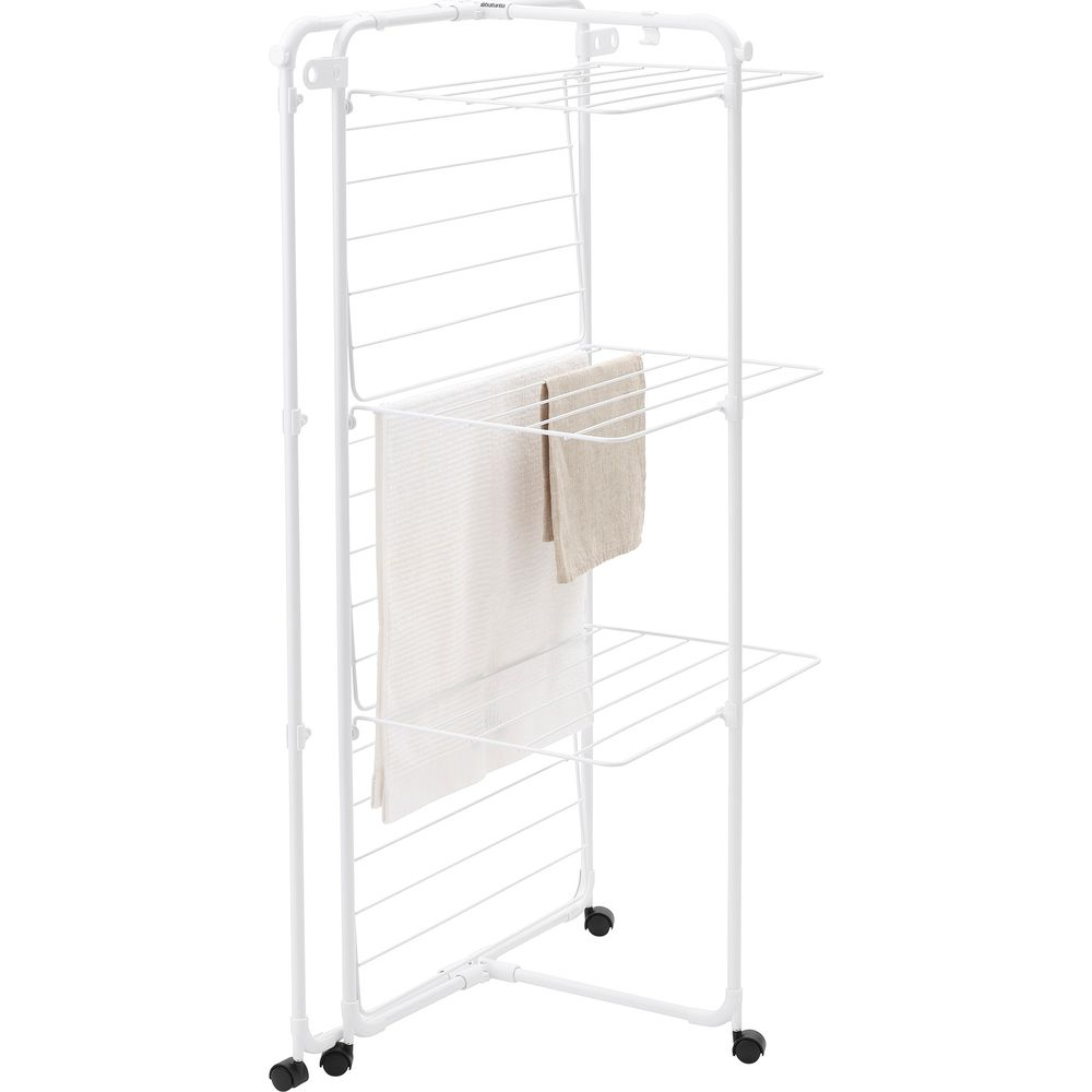 A white clothes drying rack with wheels, two towels on it.