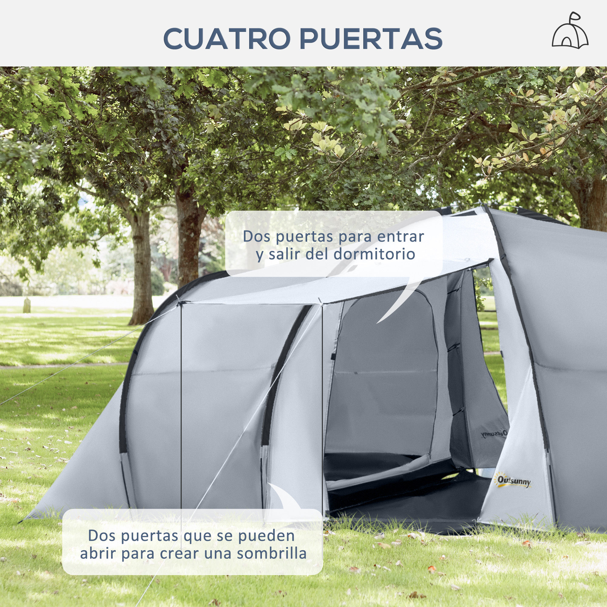 Una carpa gris con varias entradas al aire libre bajo árboles.