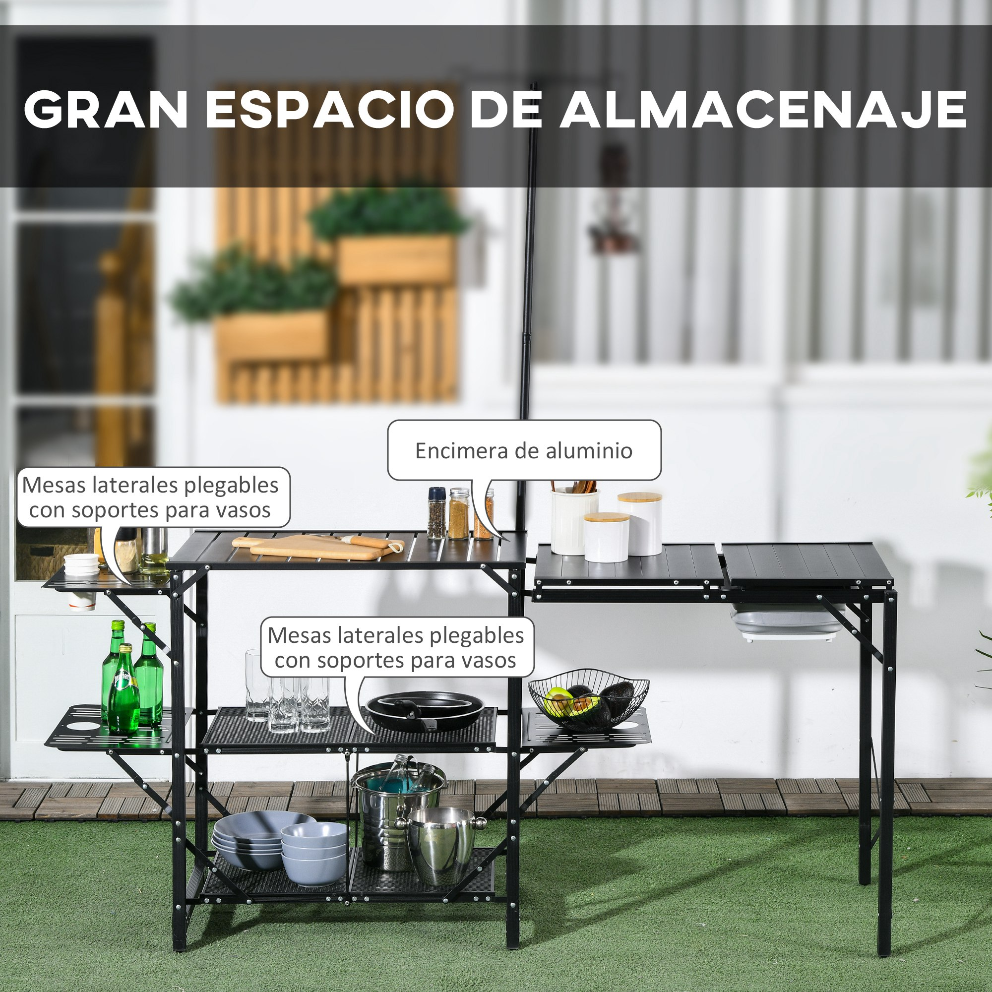 Un carrito de cocina negro con tapa de aluminio, con botellas, vasos y platos.