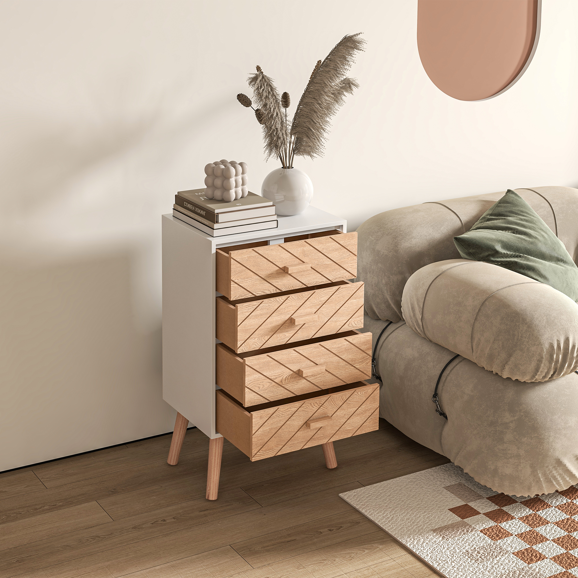 Una mesita de noche blanca con cuatro cajones de madera junto a un sofá beige con cojines verdes.