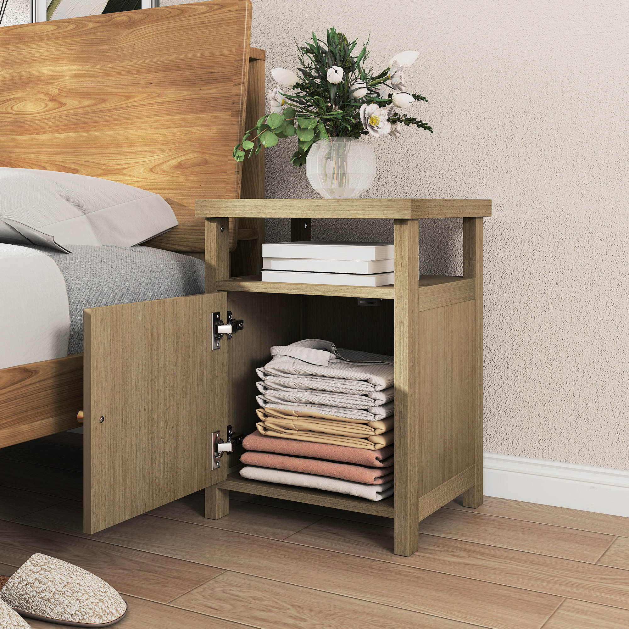 Una mesita de noche de madera con puerta abierta, llena de ropa y libros.