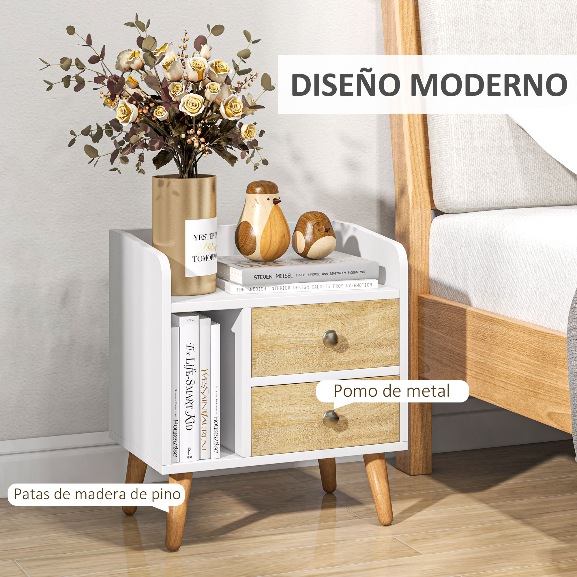 Una mesita de noche blanca y de madera con flores, libros y adornos de pájaros.