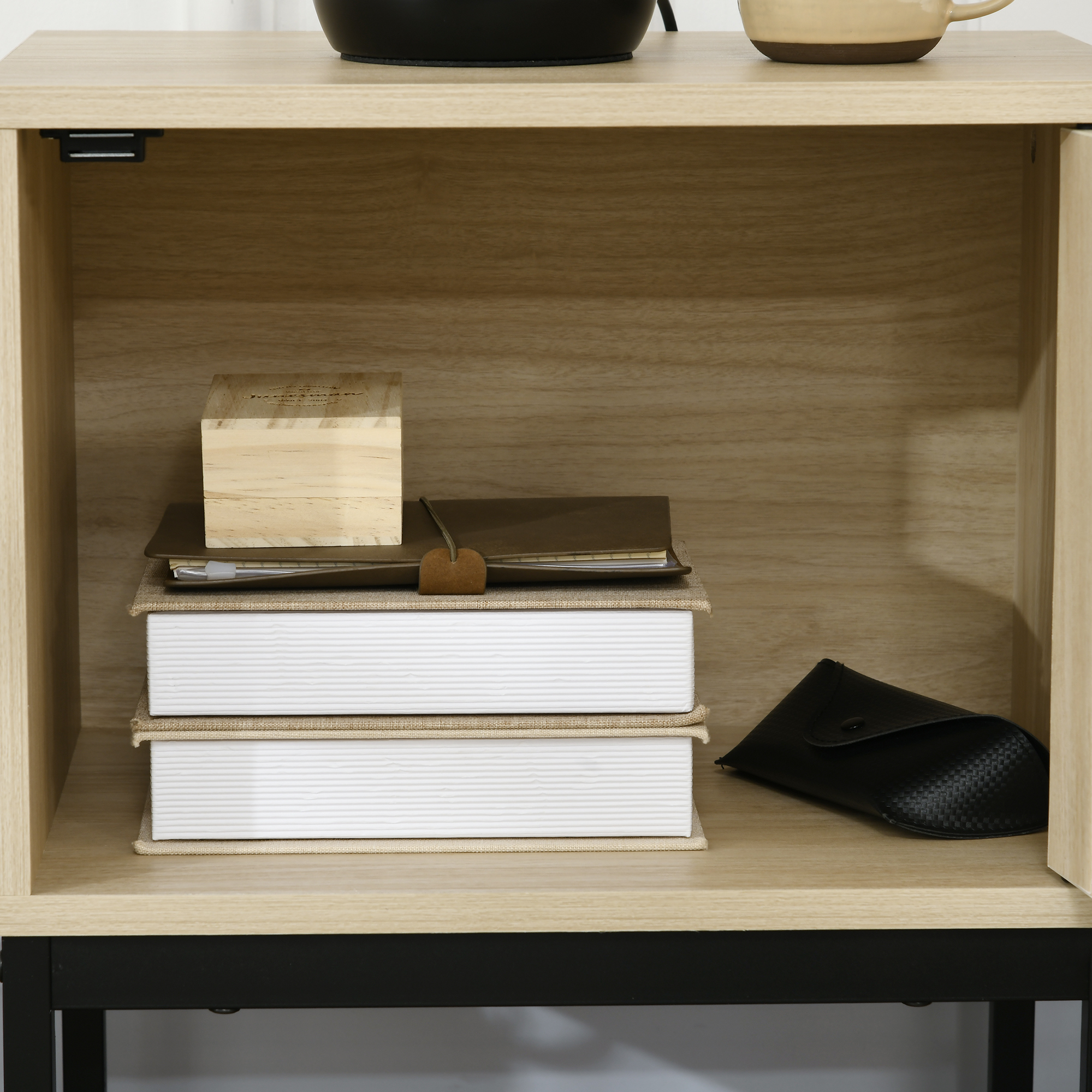 Estante de madera con libros, cuaderno, caja de madera y estuche.