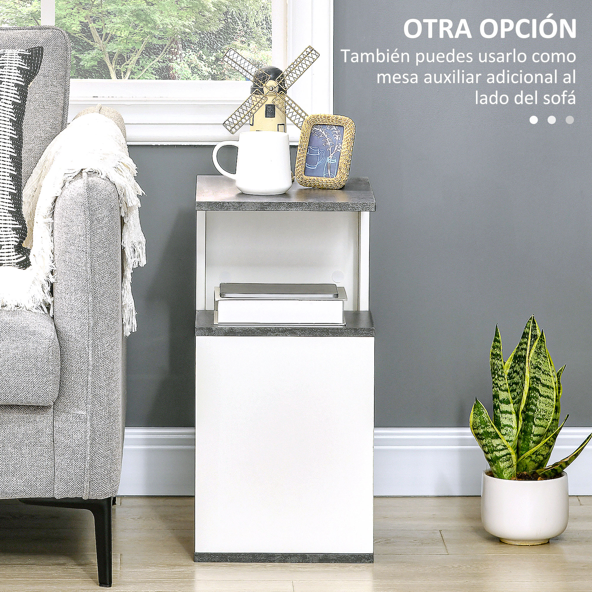 Una mesa auxiliar con mueble blanco y tapa gris, junto a un sofá.