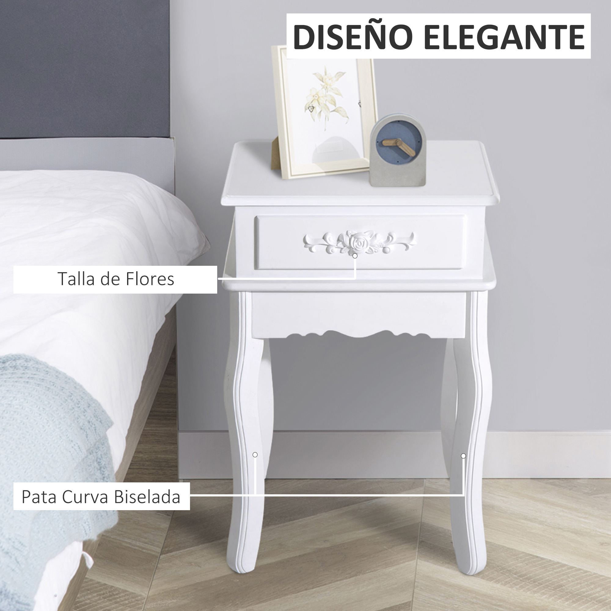 Una mesita de noche blanca con talla floral y patas curvas junto a una cama.
