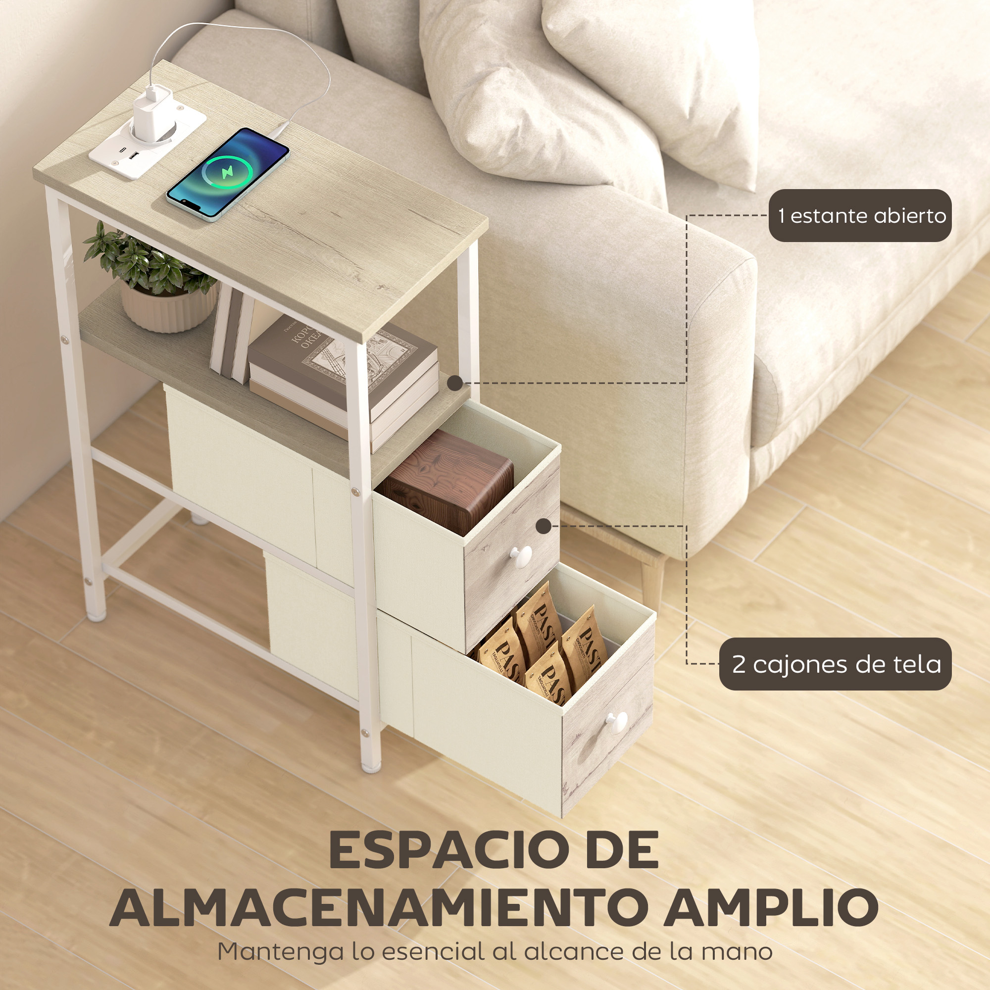 Una mesita de noche con teléfono, cargador, planta, libros y cajones junto a un sofá.