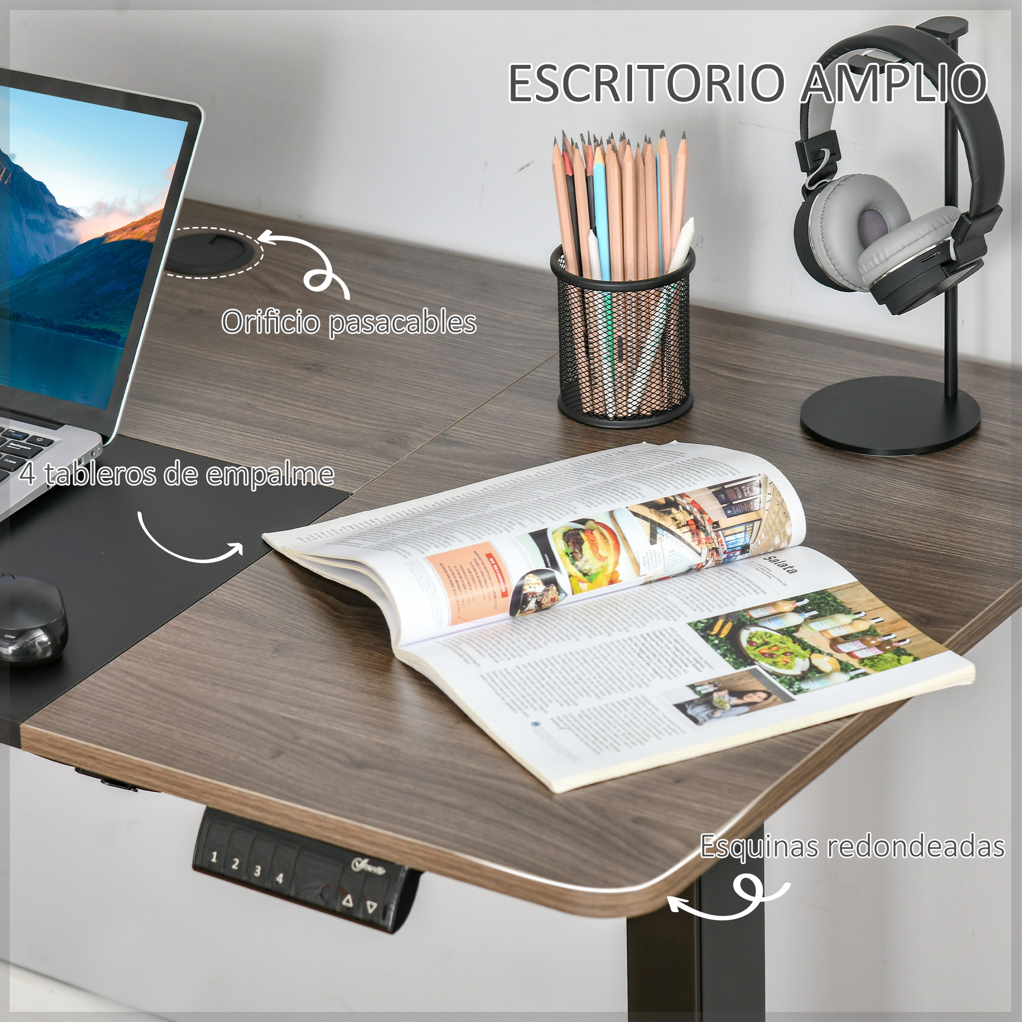 Un escritorio con portátil, ratón, auriculares, lápices y revista abierta.