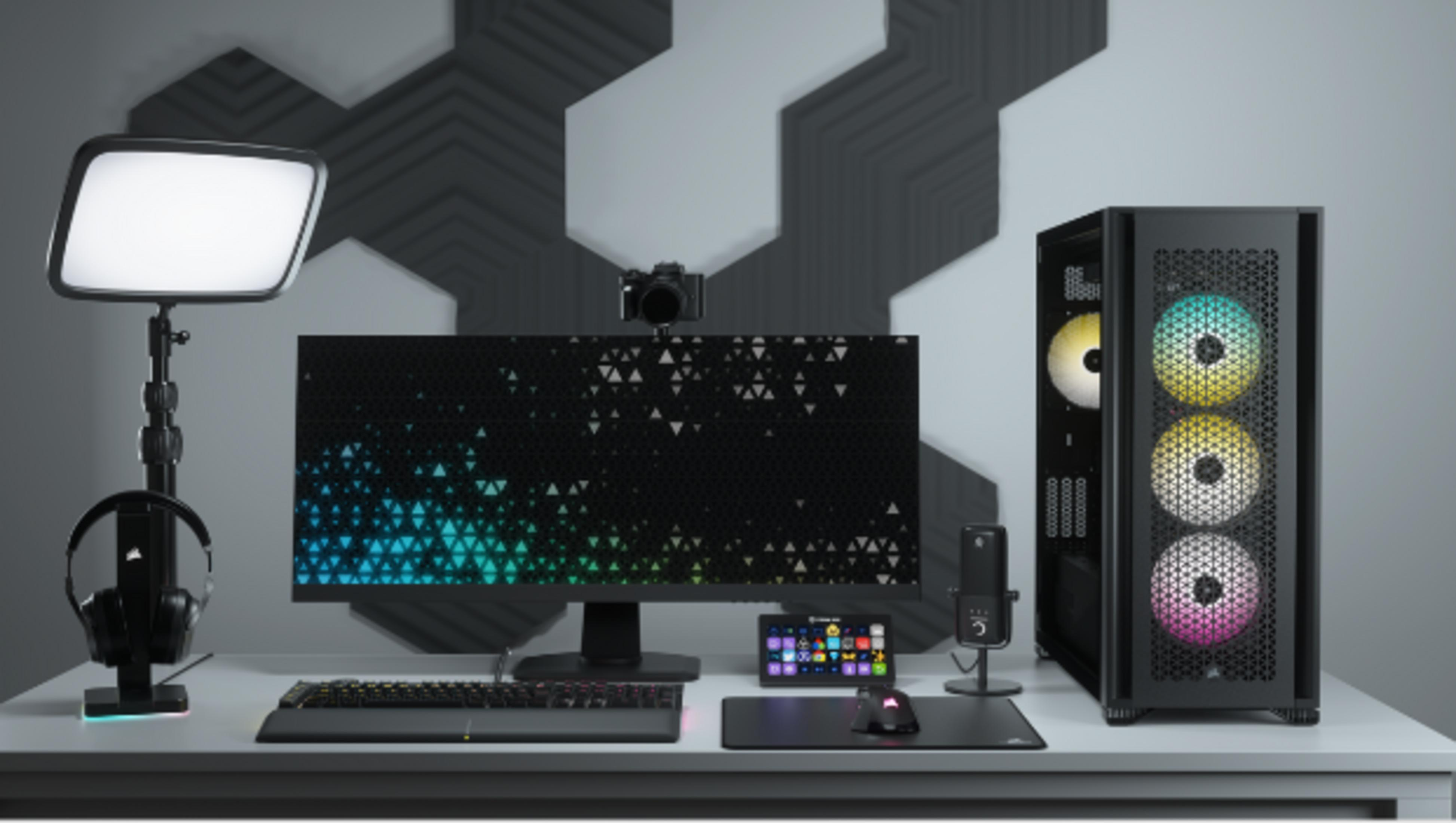 Biurko z komputerem, monitorem, klawiaturą, myszą, mikrofonem i słuchawkami.