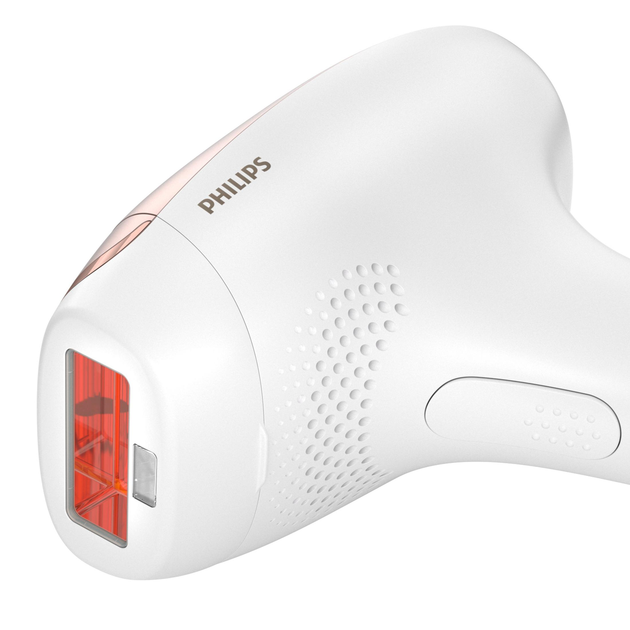 Un depilador Philips blanco con detalles en oro rosa y ventana de luz roja.