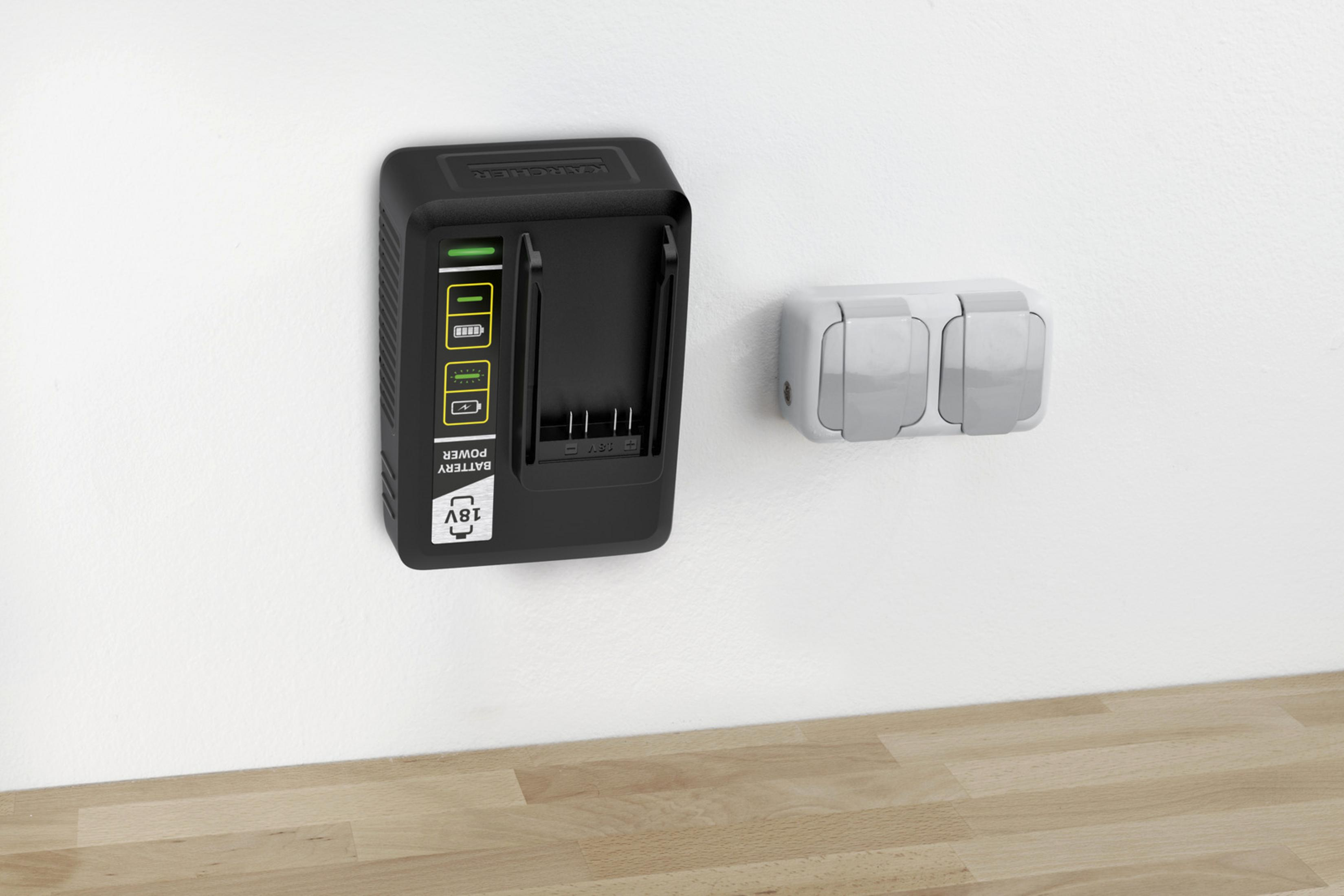 Czarna ładowarka akumulatorowa ze wskaźnikami naładowania obok białego gniazda podwójnego.