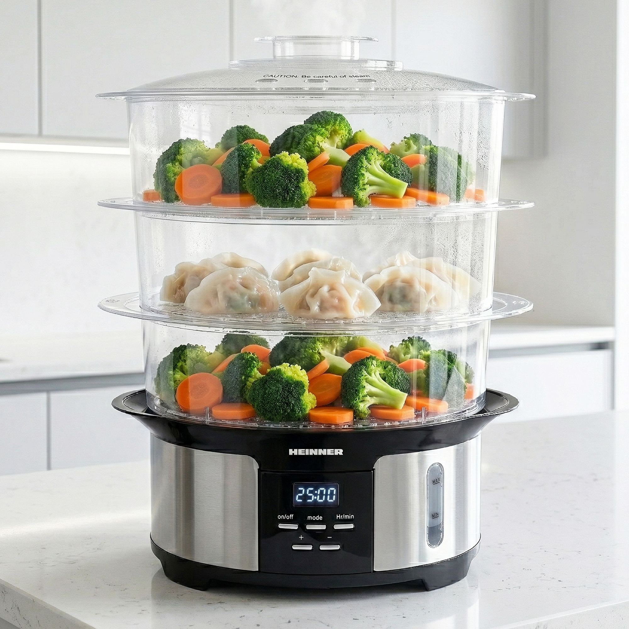 A three-tiered food steamer filled with broccoli, carrots, and dumplings.