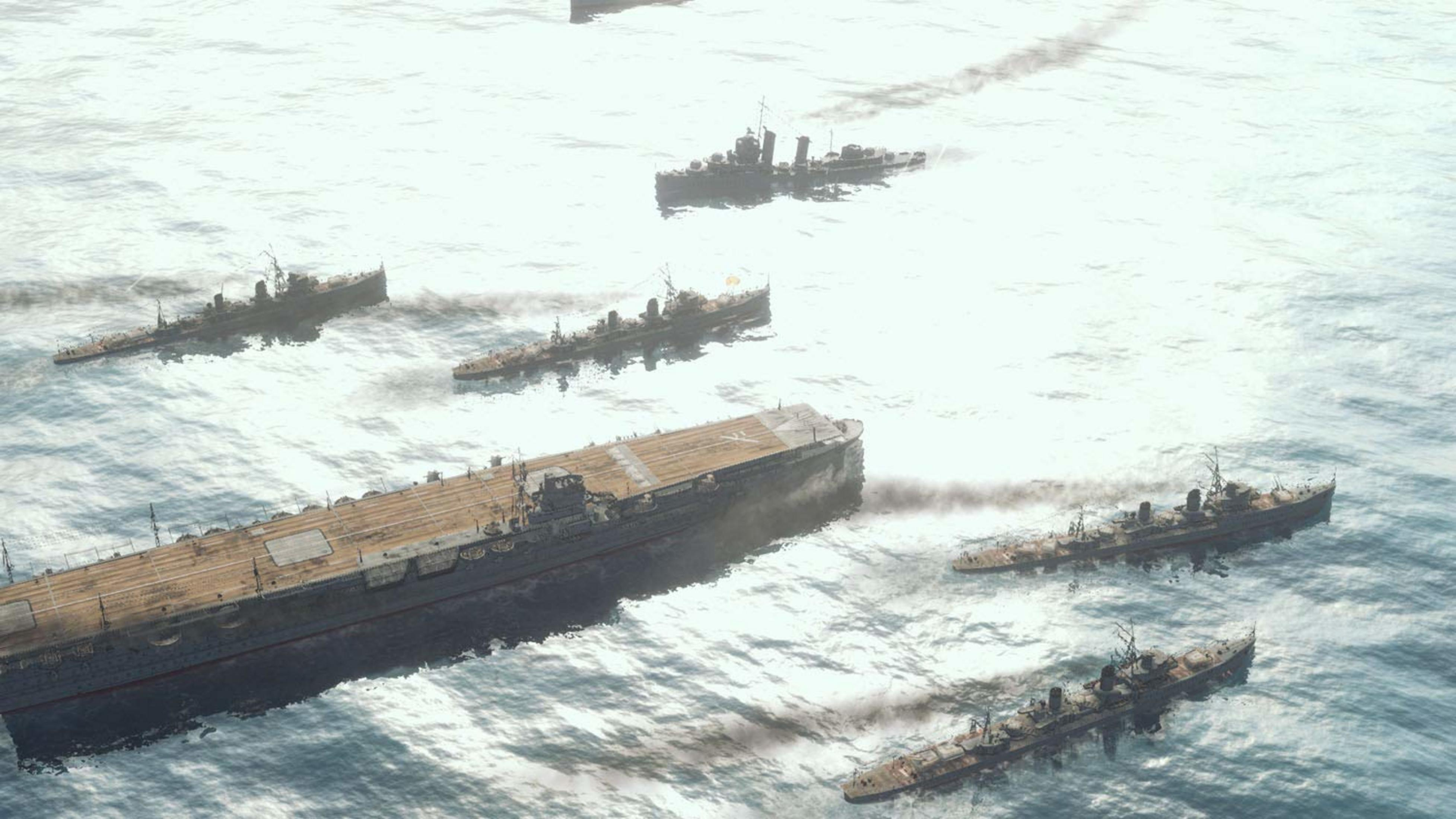 Flugzeugträger und Zerstörer auf dem Meer, Rauchsäulen steigen auf.