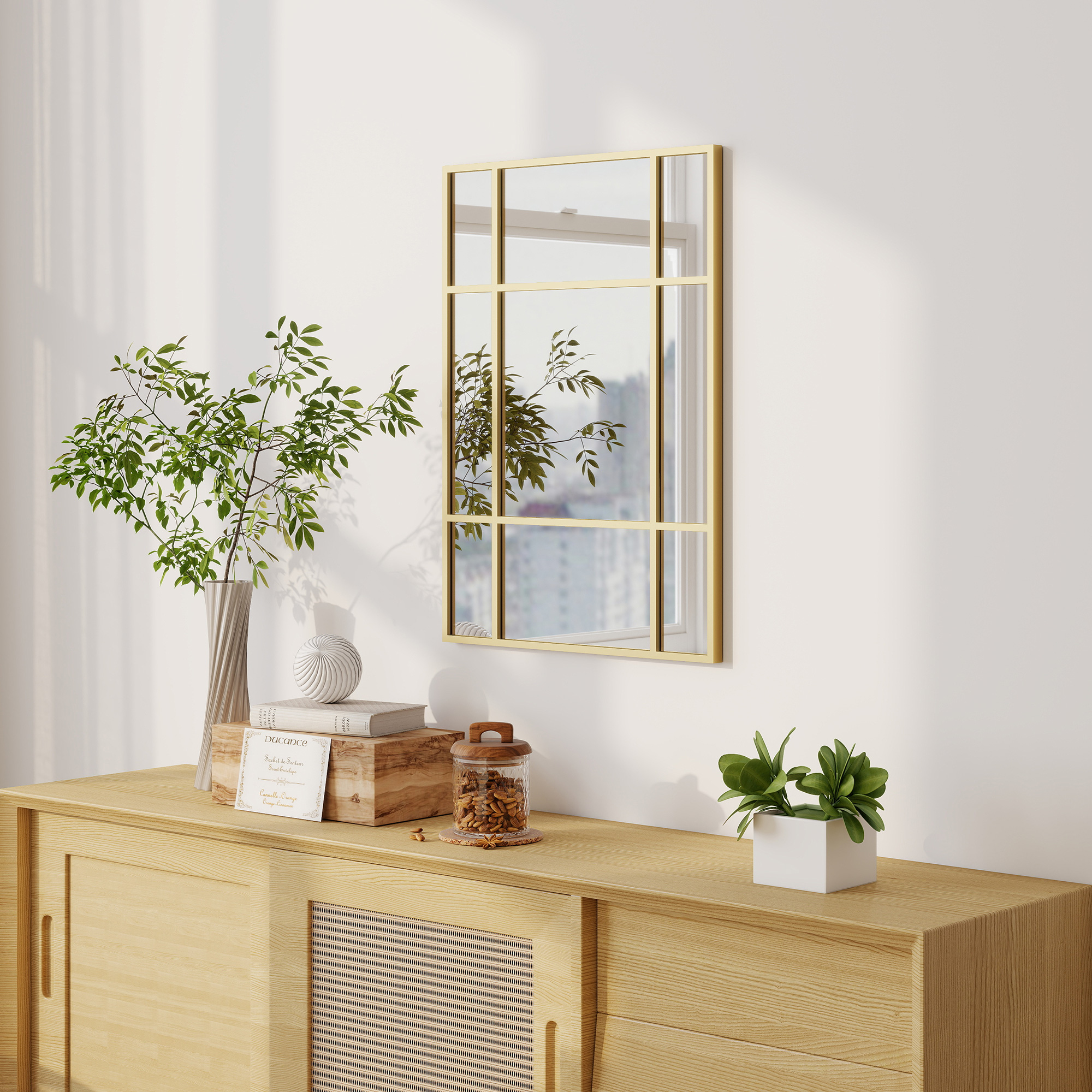 Una mesa consola de madera con plantas, libros y un espejo.