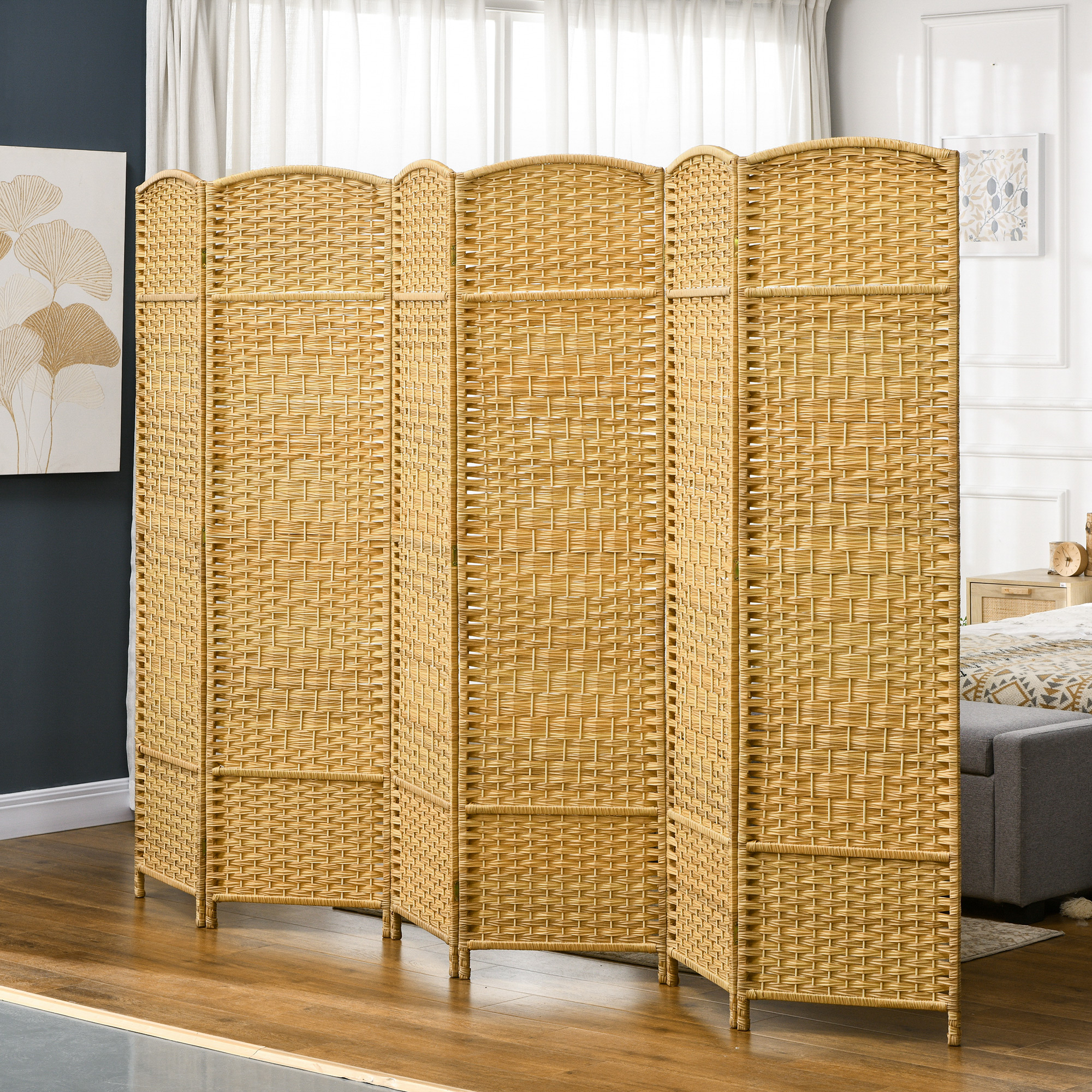Un divisor de ambiente de mimbre beige de seis paneles frente a una ventana con cortinas.