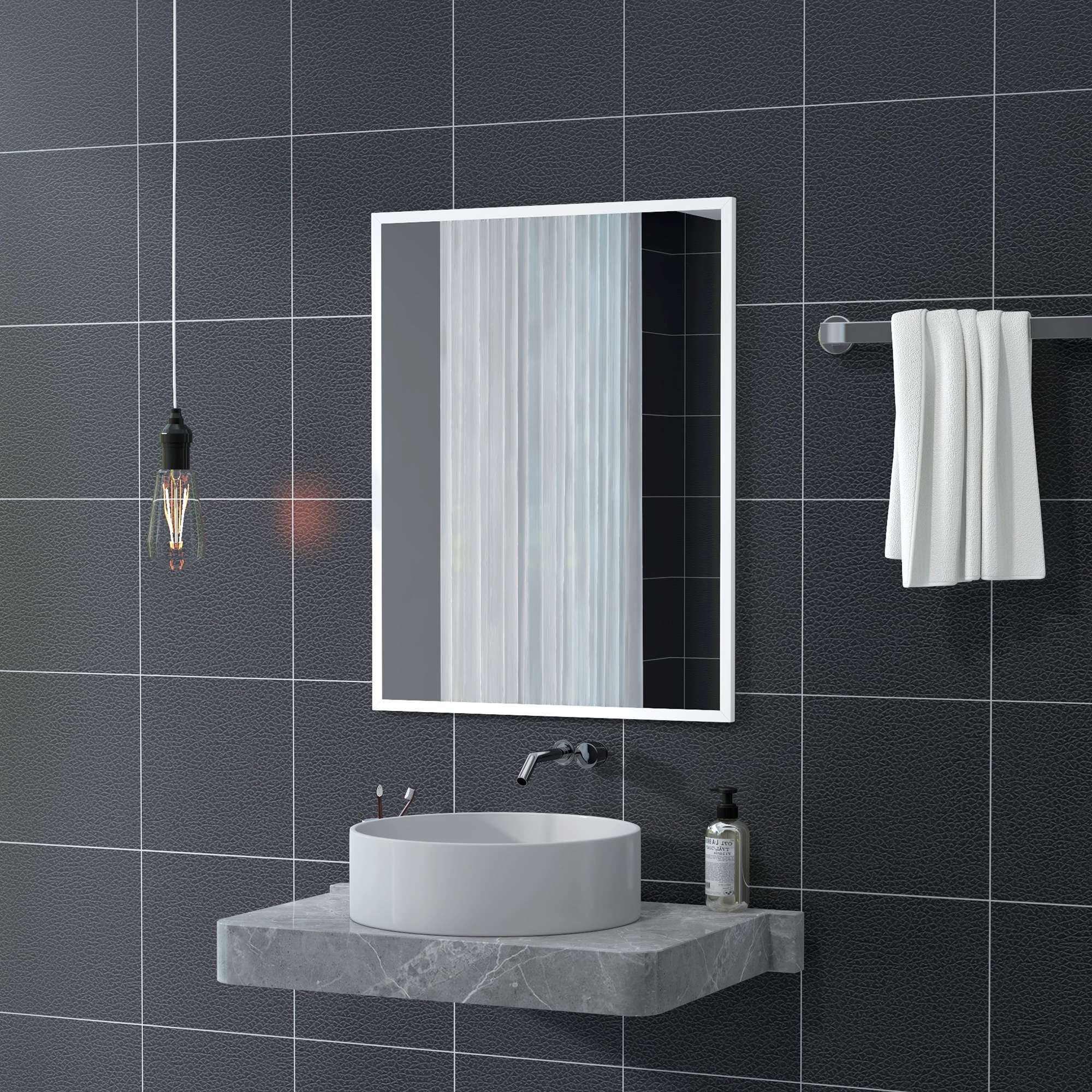 Un baño con pared de azulejos negros, espejo, lavabo y toalla.