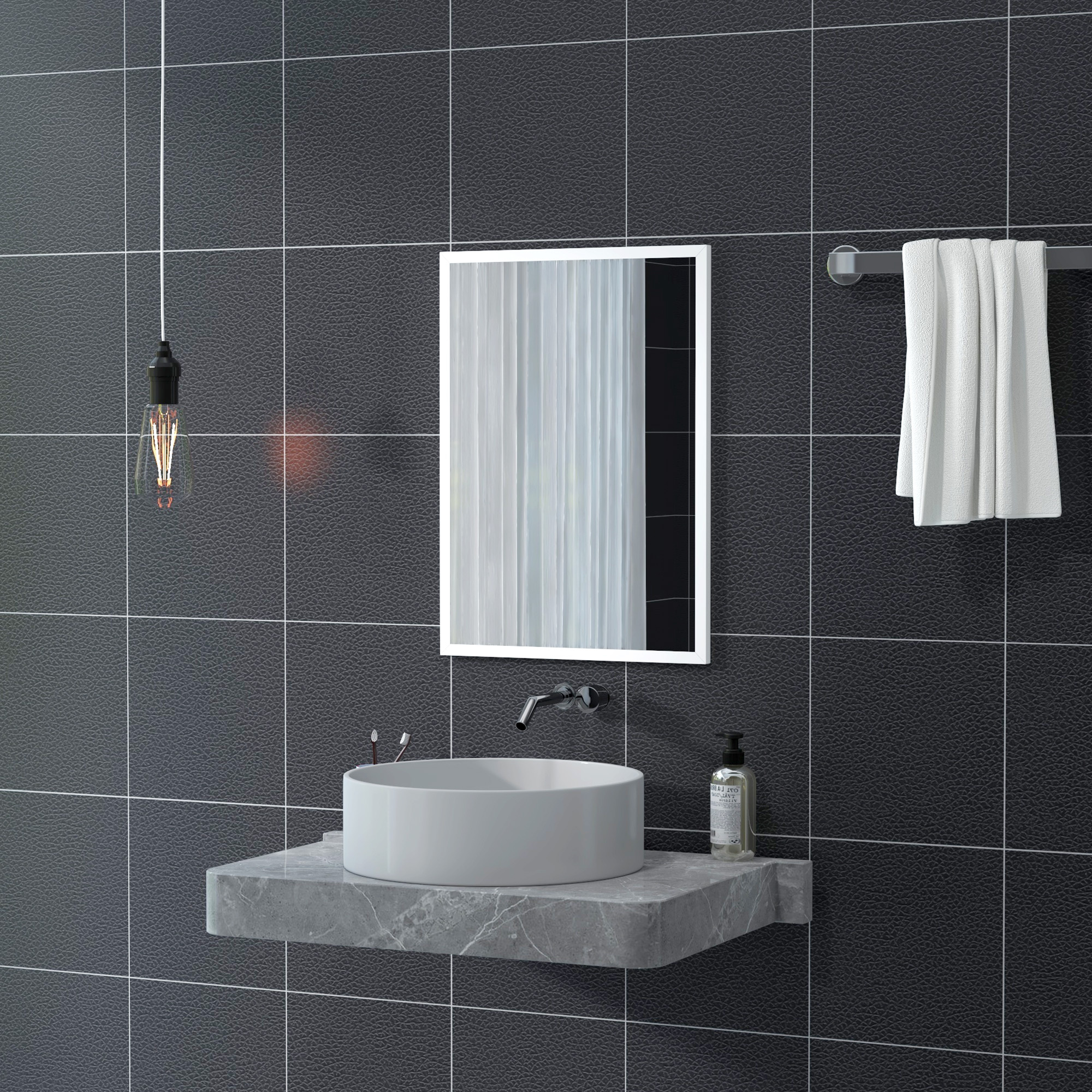 Un baño moderno con azulejos negros, lavabo, espejo y toallero.