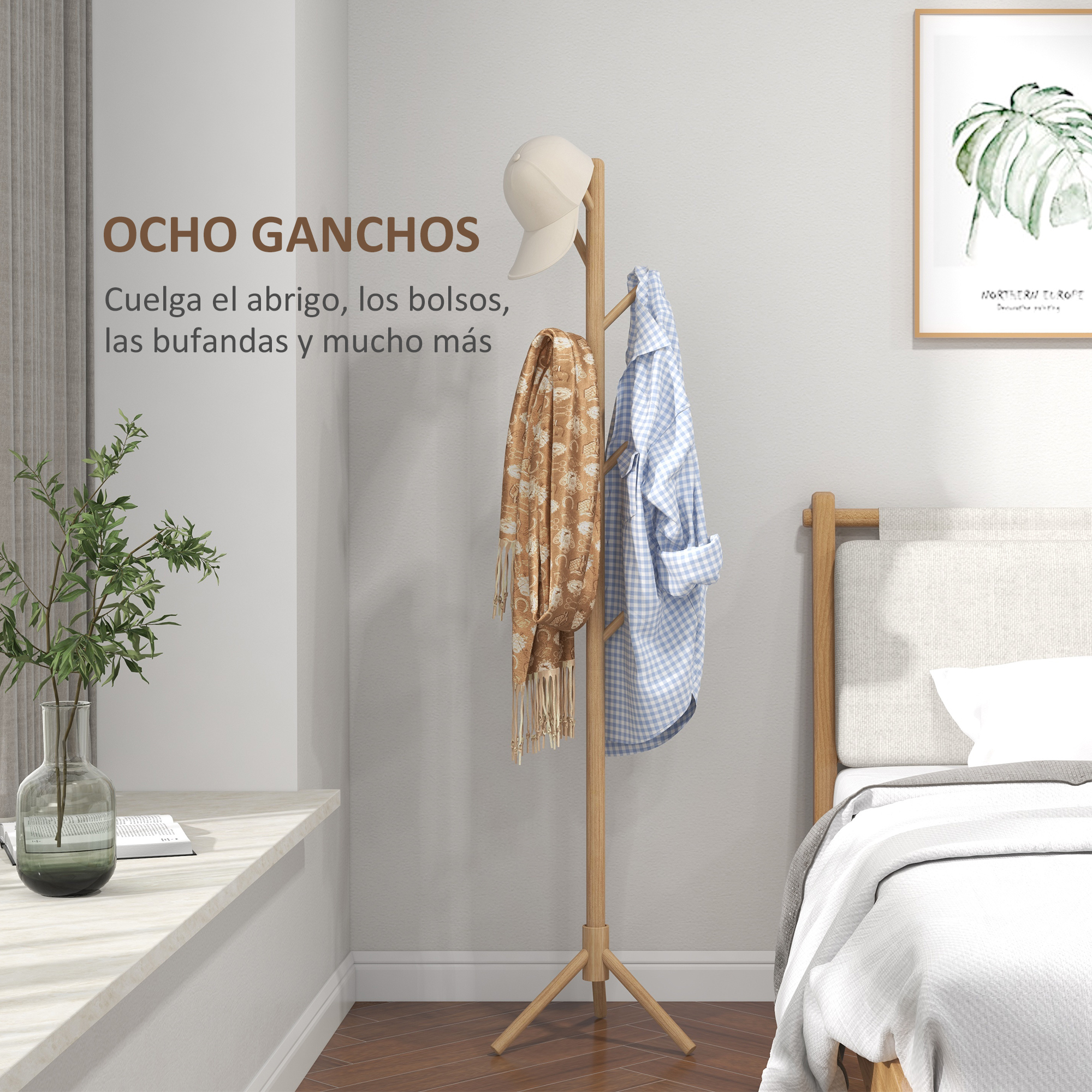 Un perchero con gorra, bufanda y camisa, junto a una cama.