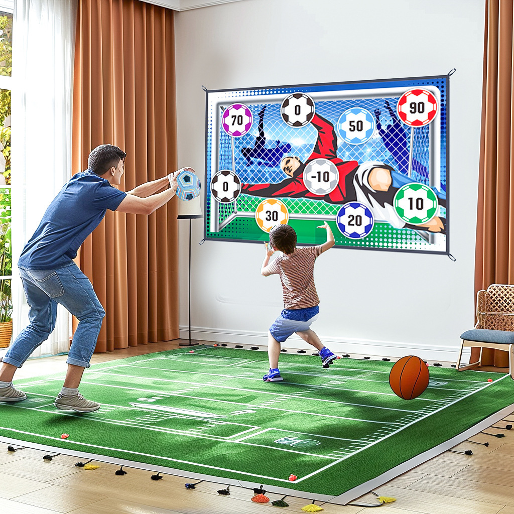 Vater und Sohn spielen ein Fußball-Zielspiel in einem Wohnzimmer auf einer Rasenmatte.