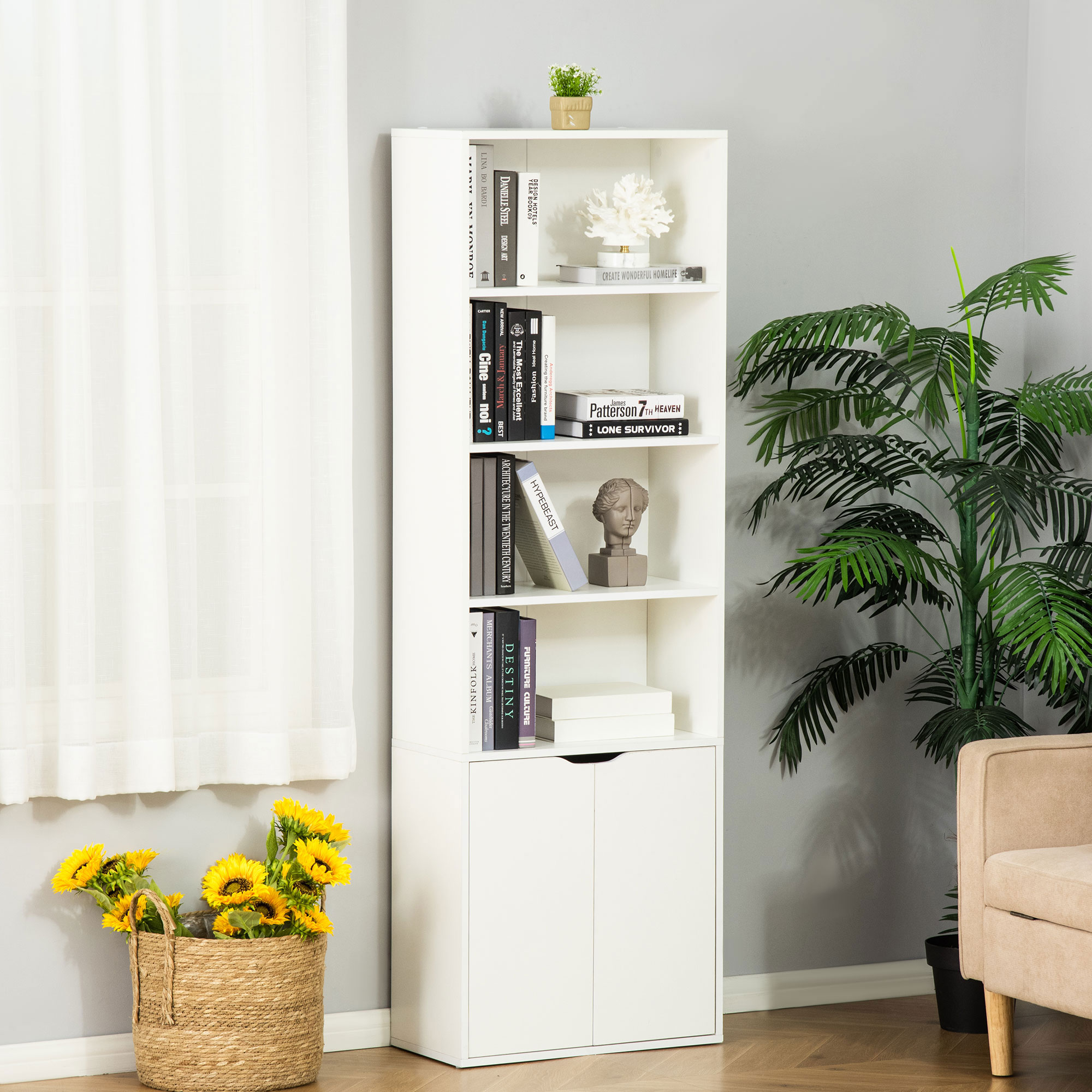 Una estantería blanca con libros, decoración, una planta en maceta y girasoles.