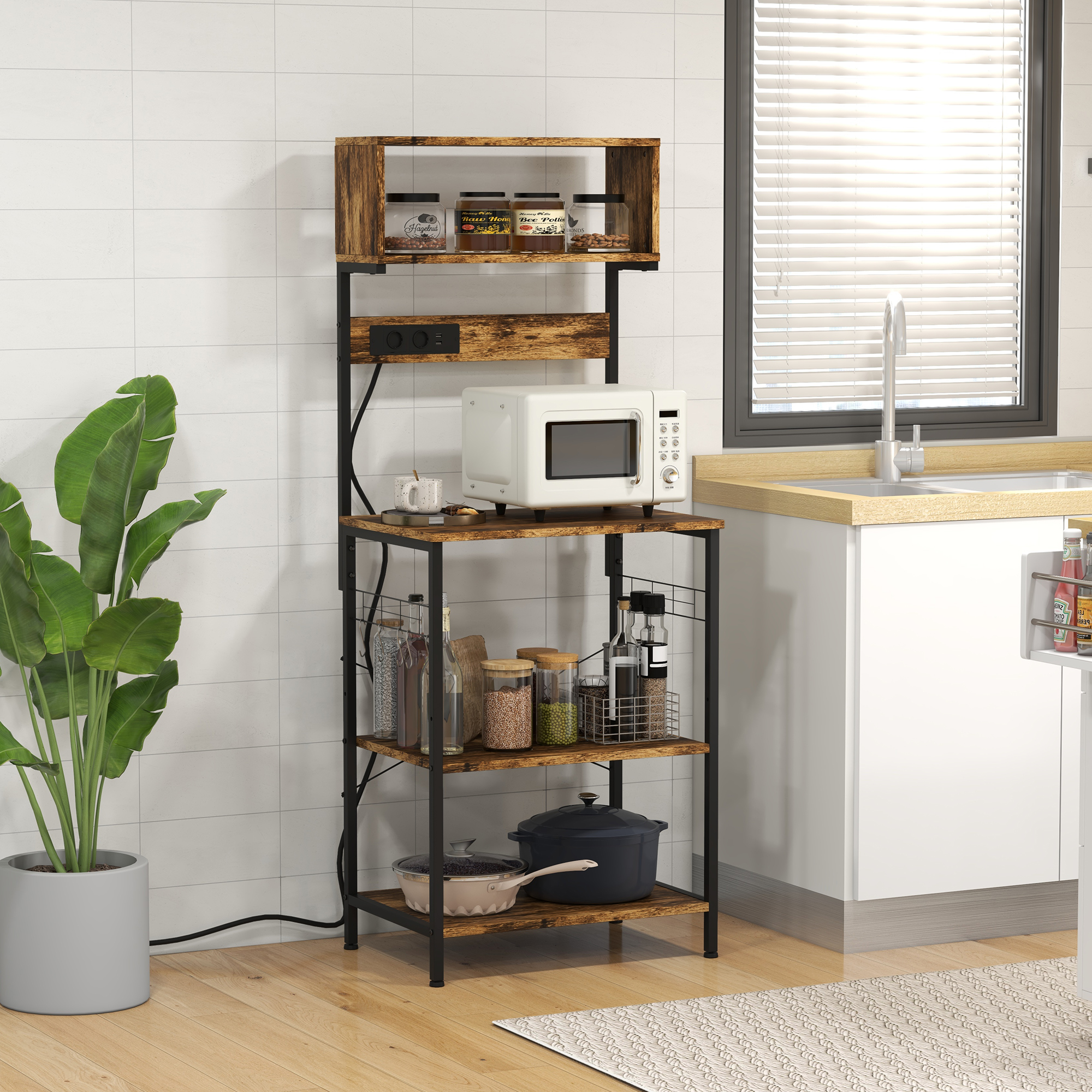 Un estante de cocina con microondas, utensilios y suministros junto a una ventana.