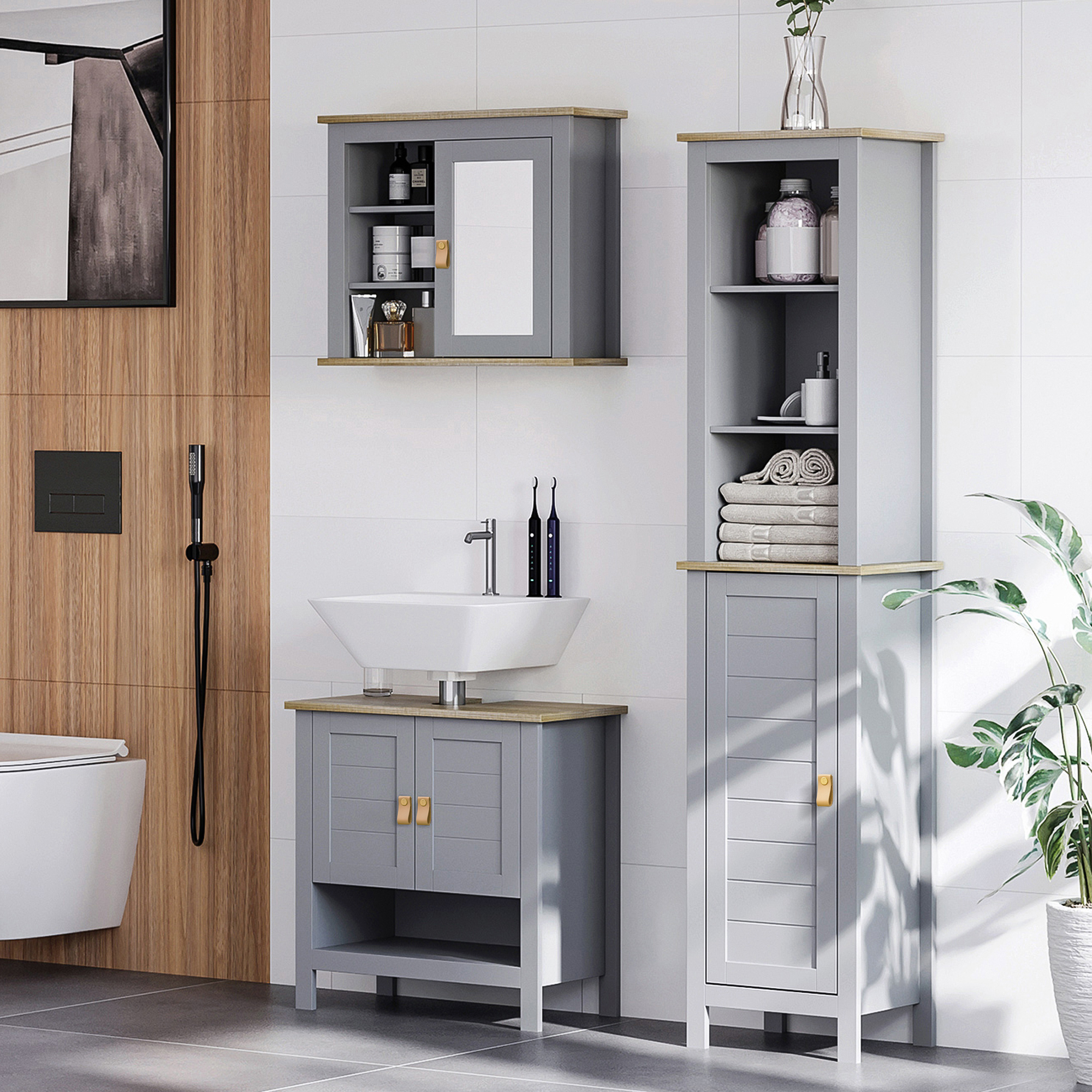 Baño moderno con muebles grises, lavabo, inodoro y plantas.