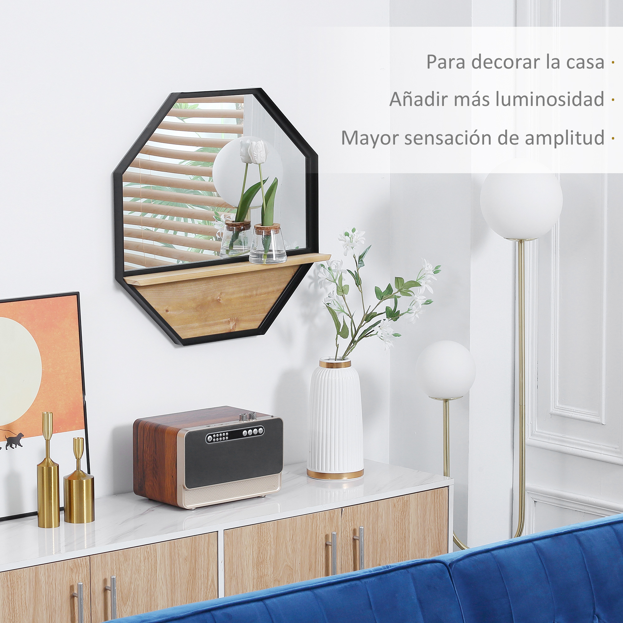 Un espejo octogonal sobre un mueble con objetos decorativos.