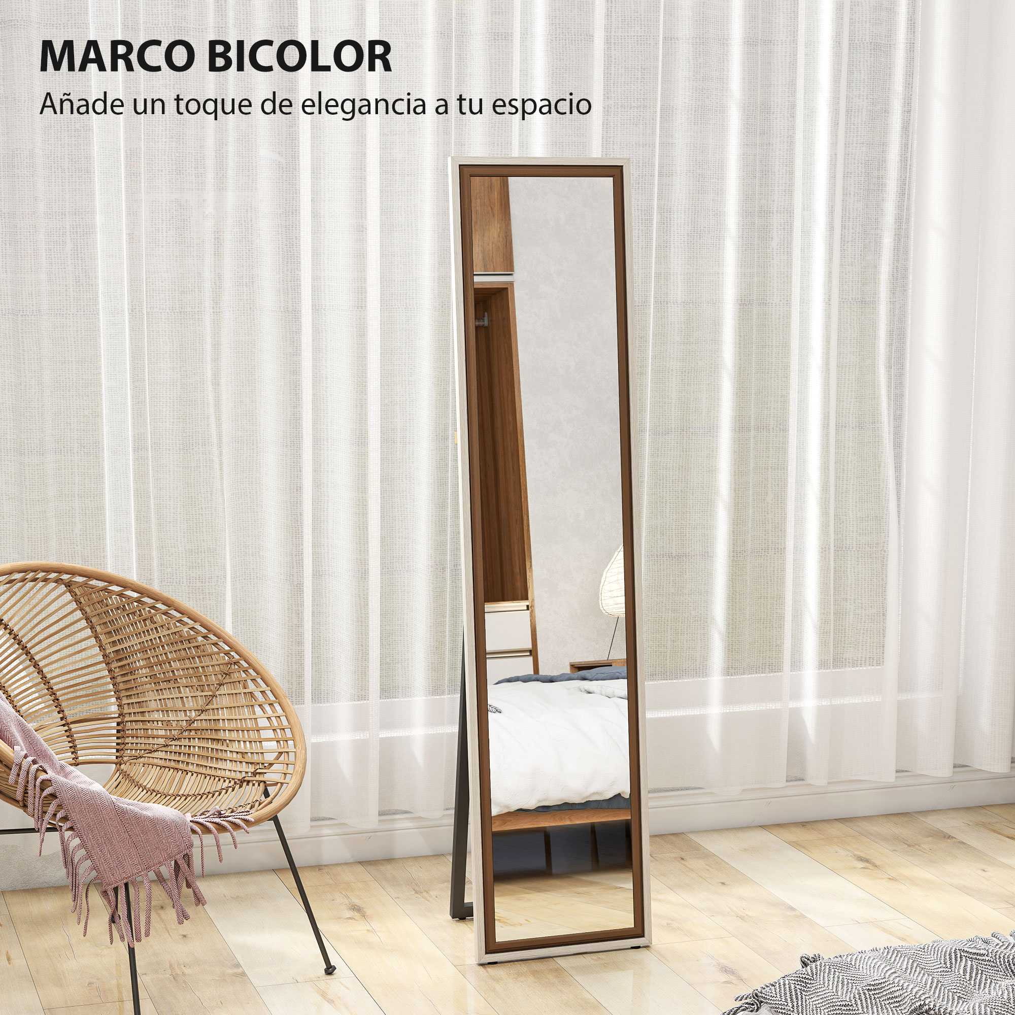 Un espejo de cuerpo entero con marco marrón y claro junto a un sillón de mimbre con manta.
