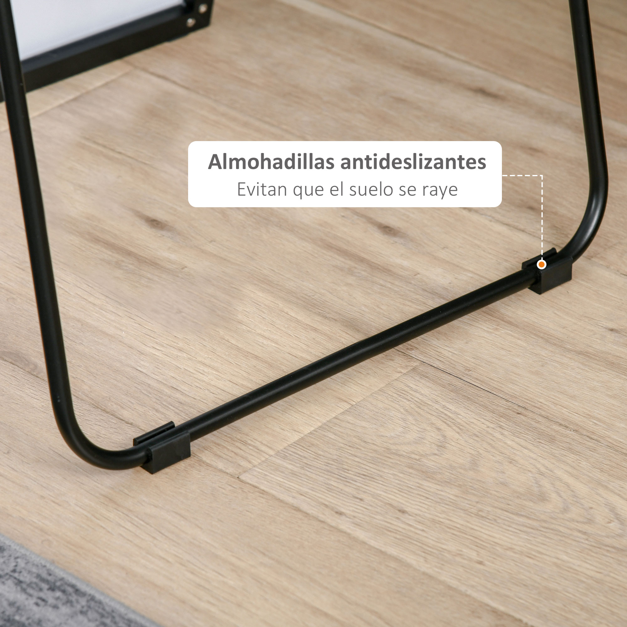 Patas metálicas negras con almohadillas antideslizantes sobre suelo de madera.