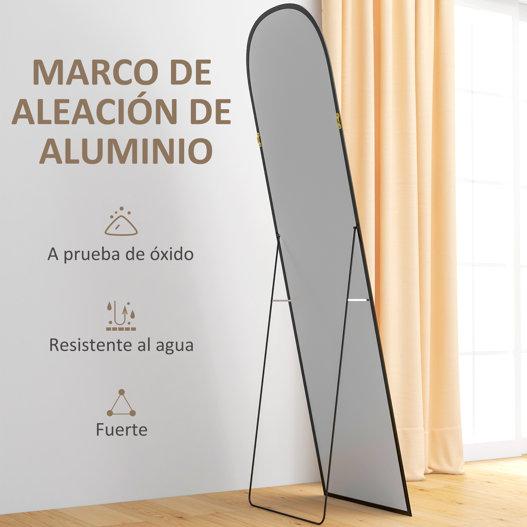 Un espejo ovalado grande con marco negro sobre suelo de madera junto a cortinas beige.