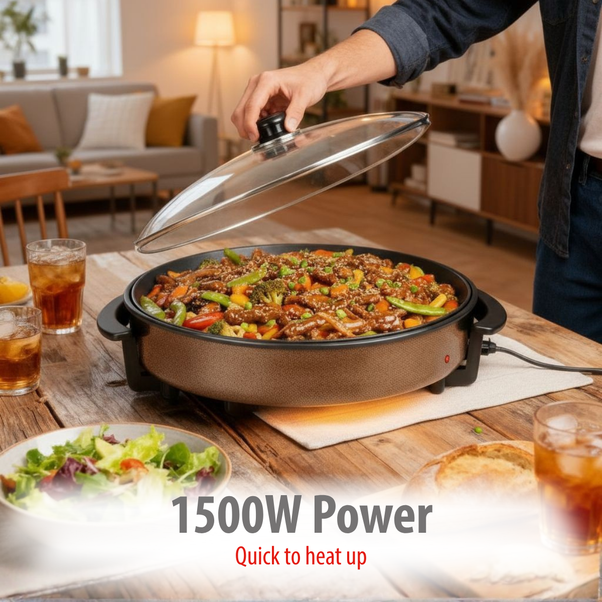 A person lifts a glass lid off a large electric skillet filled with stir-fry.
