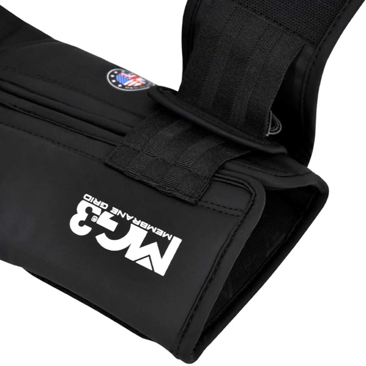 Black glove with white MG3 logo and strap fastening.