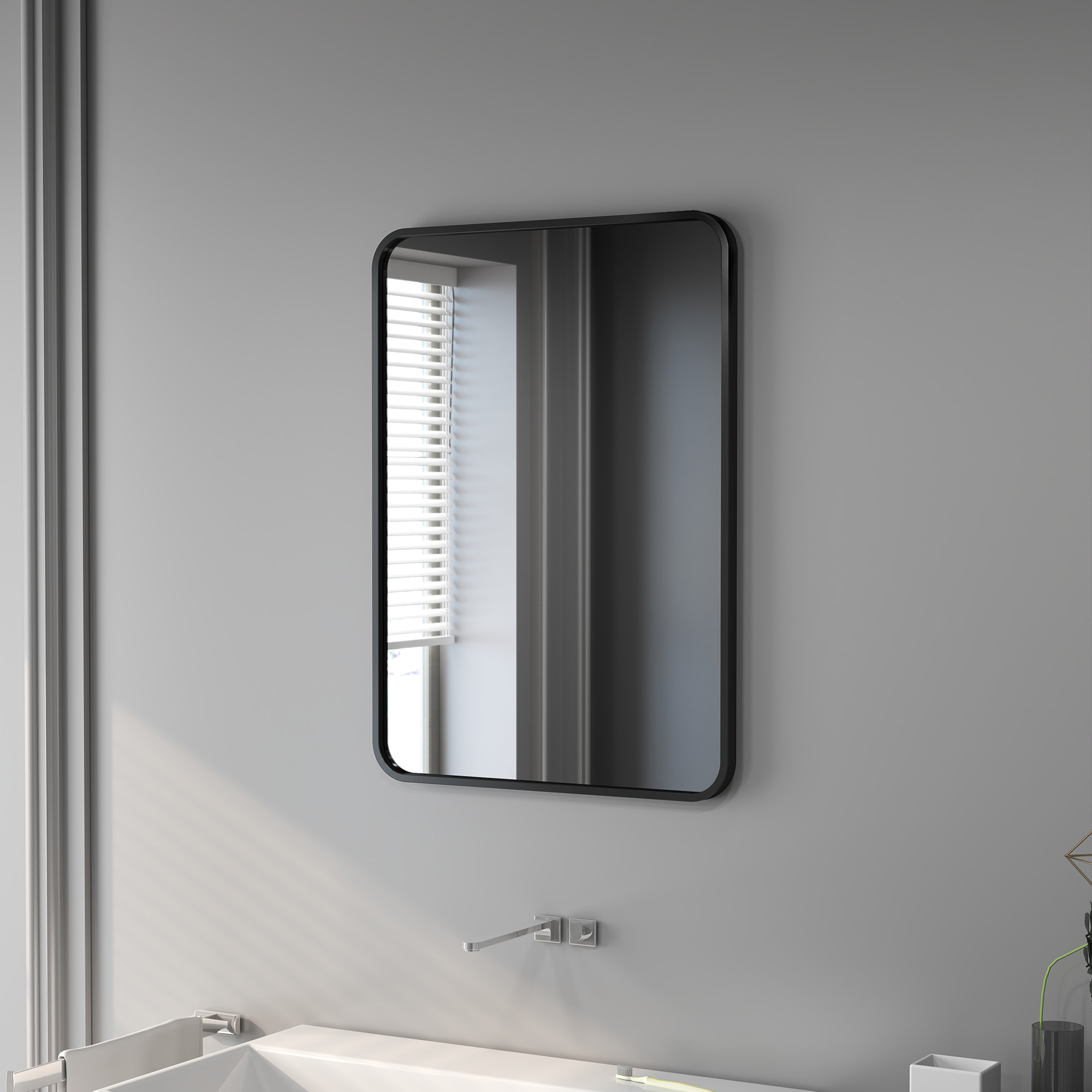 Un espejo de baño moderno sobre un lavabo con grifo.