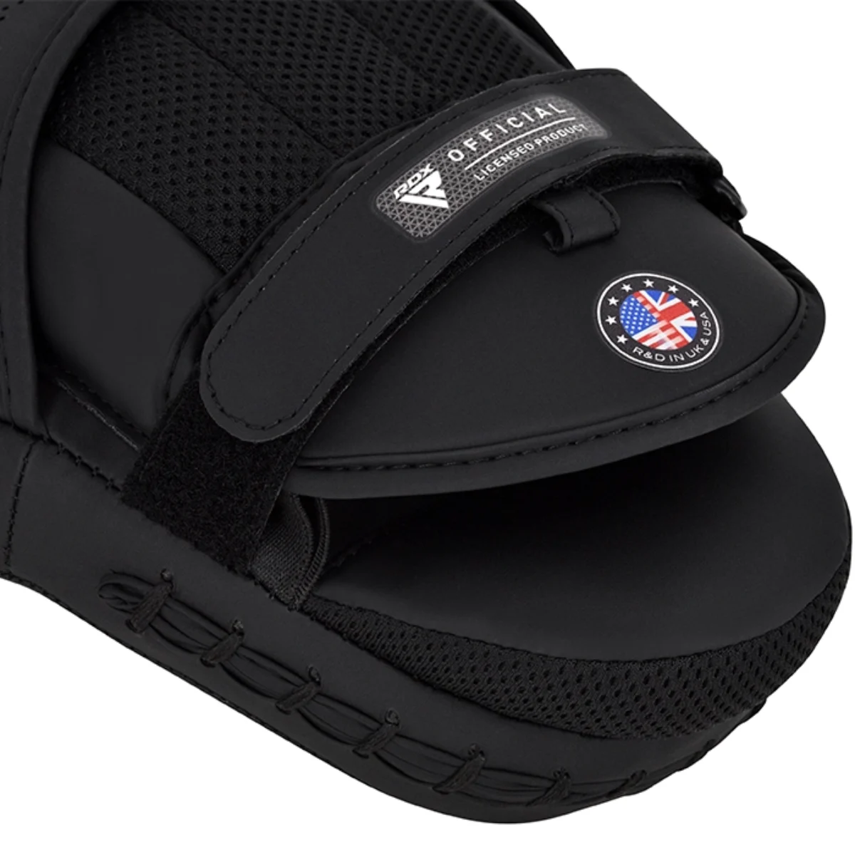 Black boxing mitt with velcro straps and logo patches.