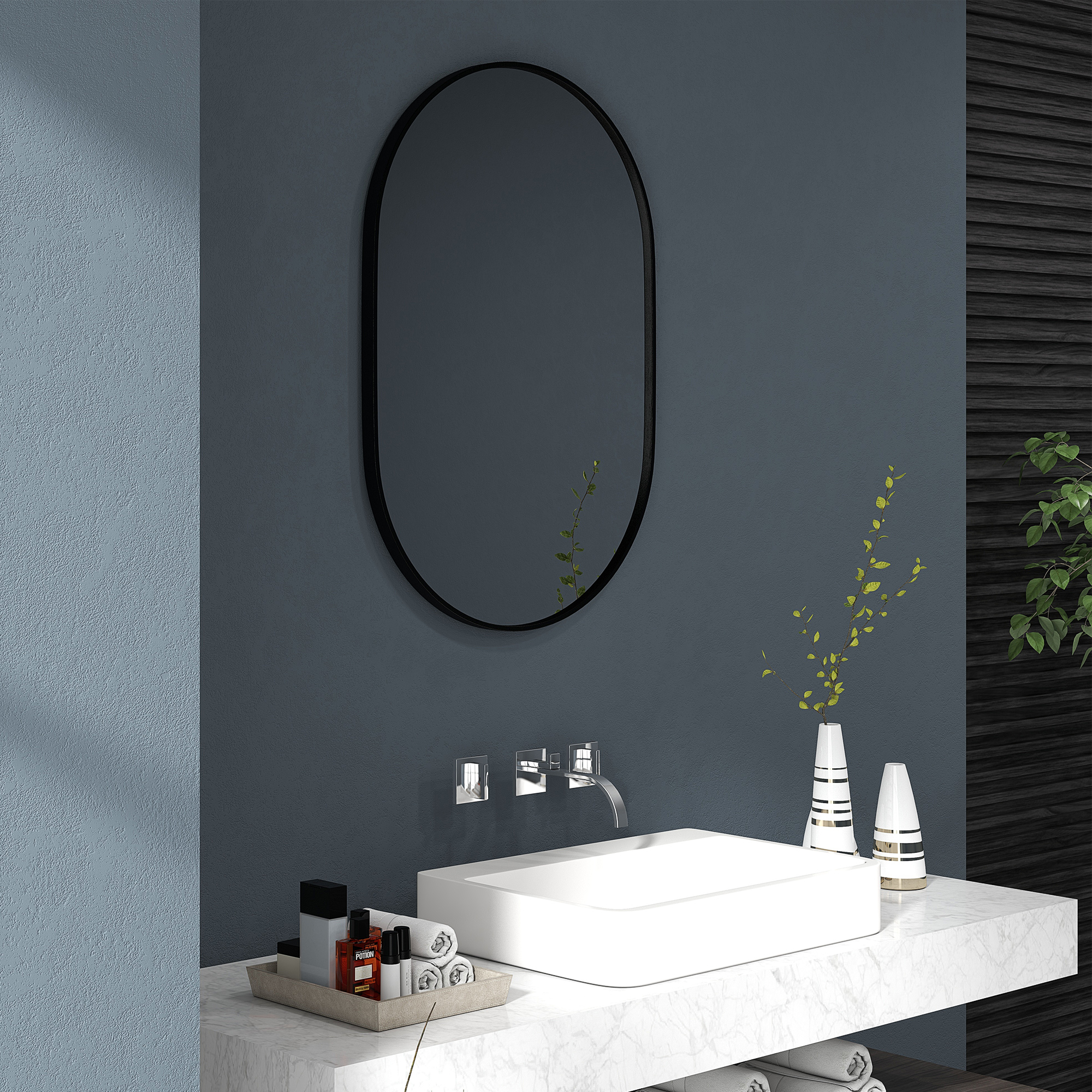 Un baño moderno con lavabo blanco, espejo y decoración.