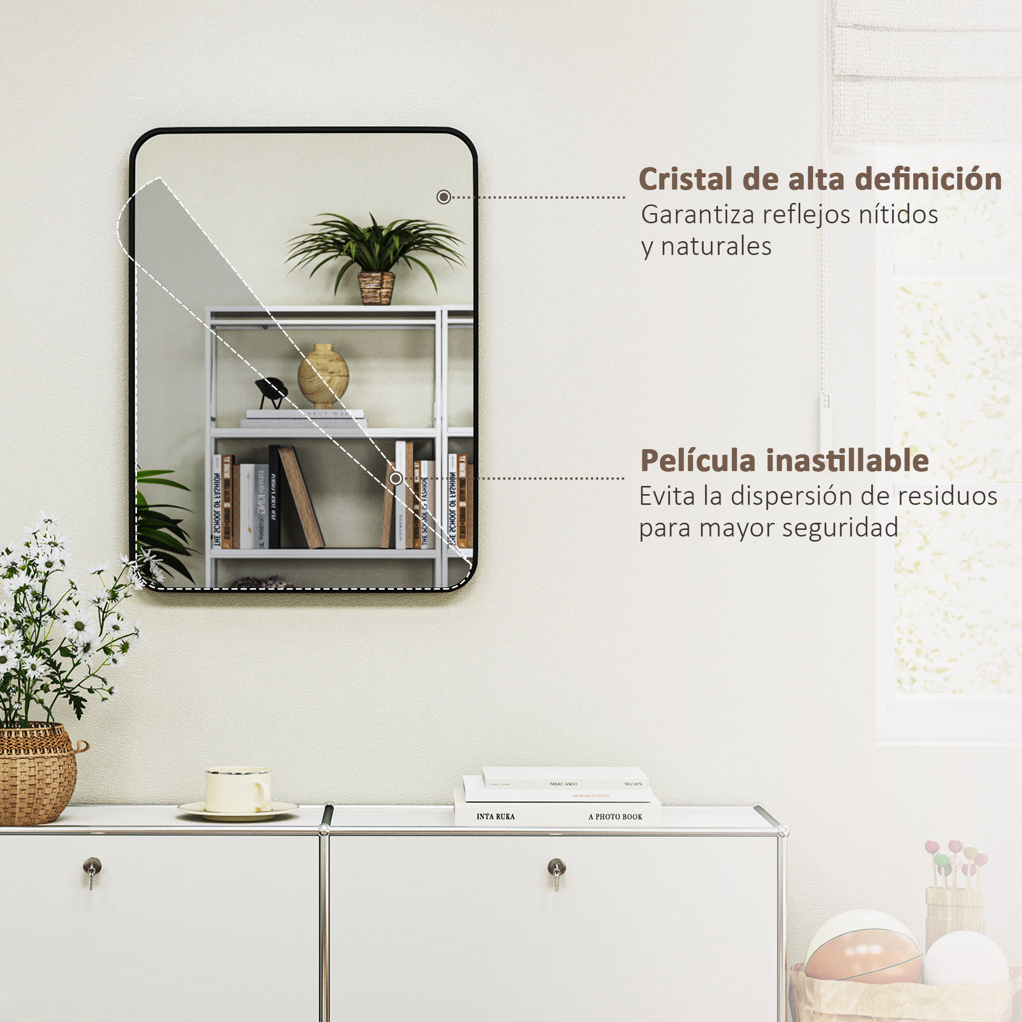 Un espejo enmarcado sobre un mueble blanco con libros y una taza.