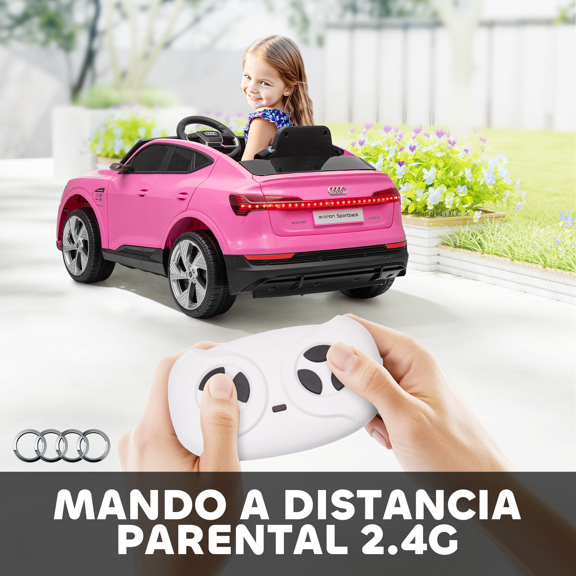 Un coche eléctrico Audi rosa con una niña y un mando a distancia al aire libre.