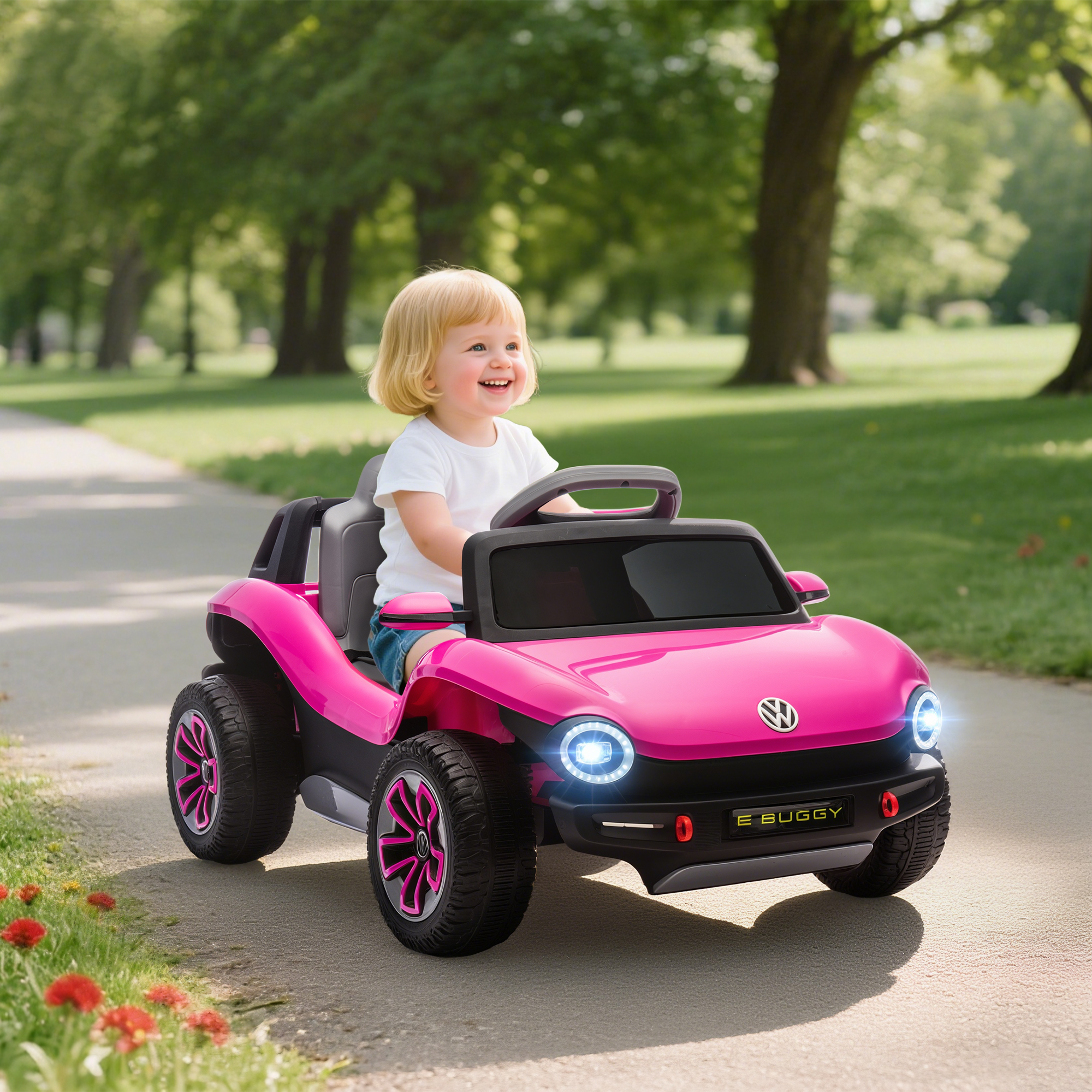 Una niña conduce un coche eléctrico rosa por un camino de parque.