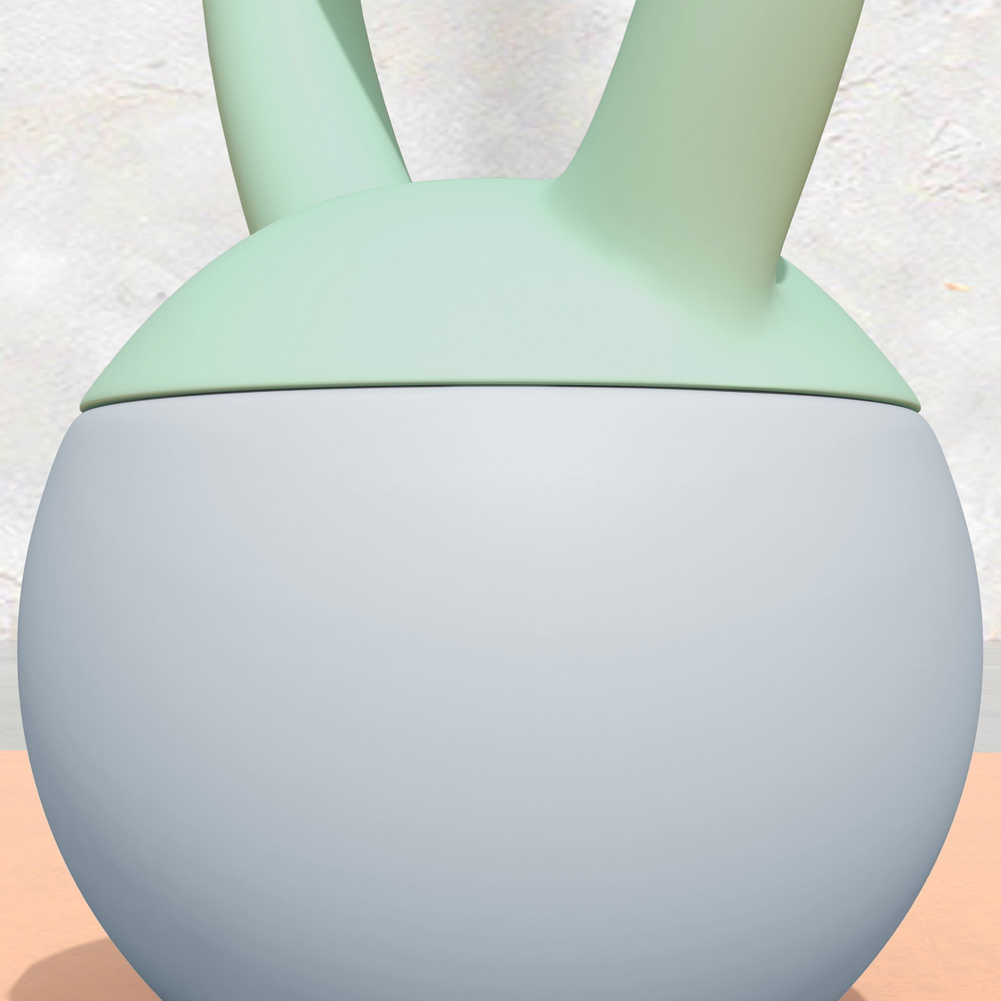 Una gorra verde se asienta sobre un cuerpo esférico gris. La gorra tiene dos orejas que apuntan hacia arriba.