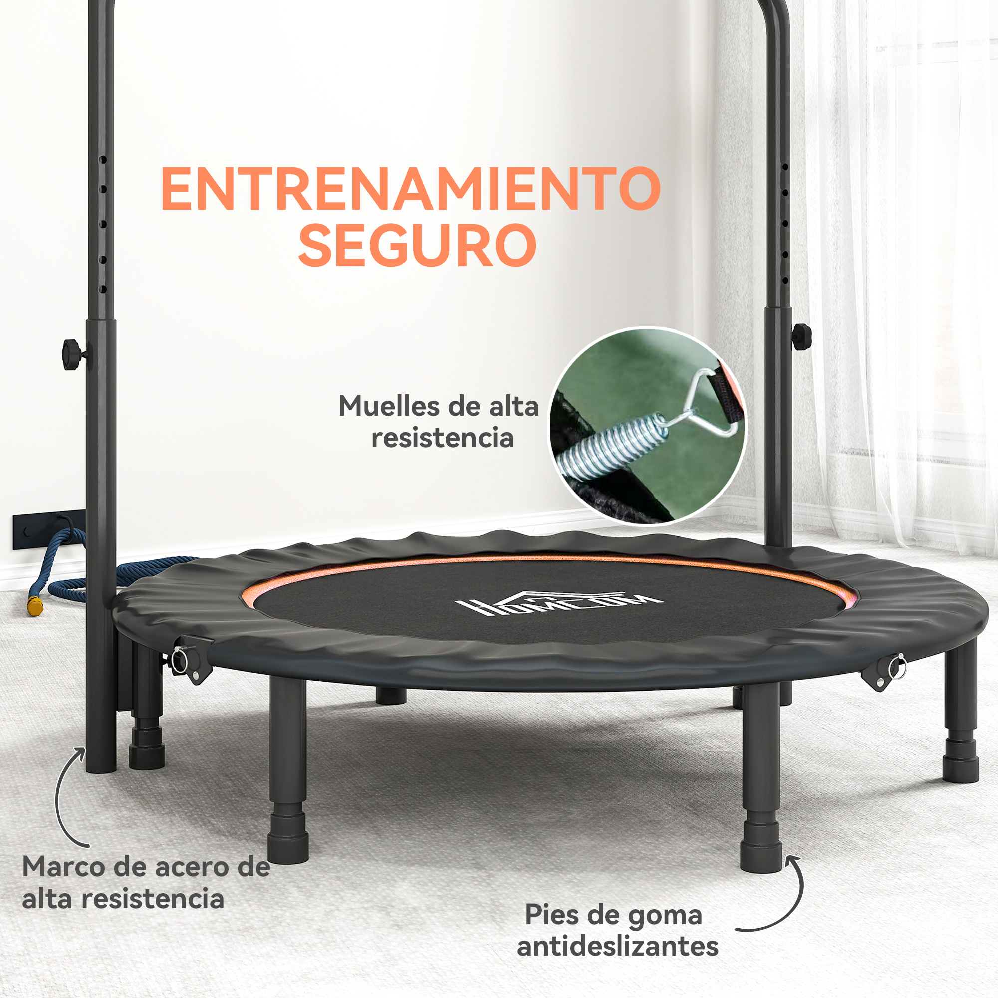 Un trampolín negro con marco de acero y pies de goma sobre una alfombra.