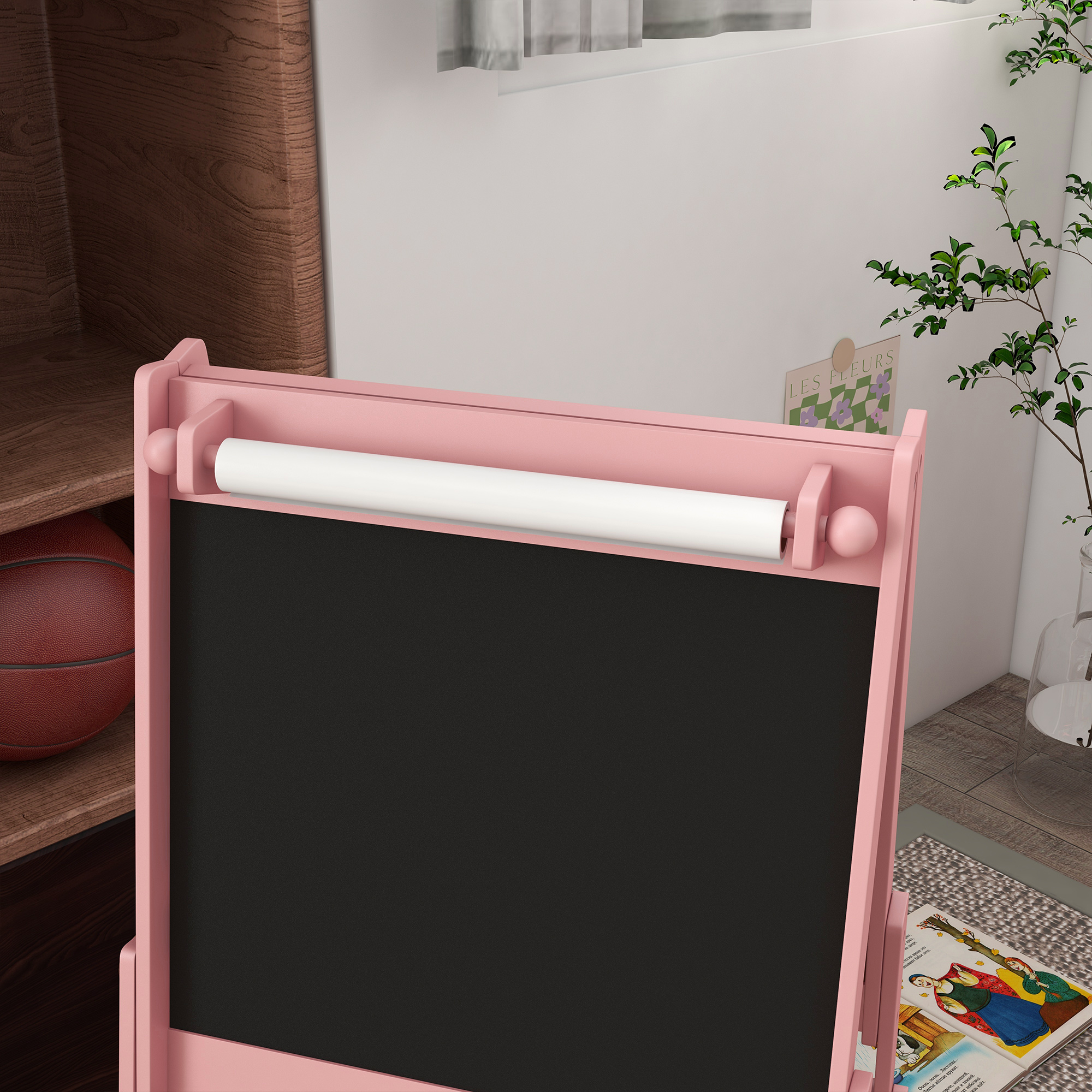 Caballete rosa con pizarra y rollo de papel. Hay una pelota de baloncesto cerca.