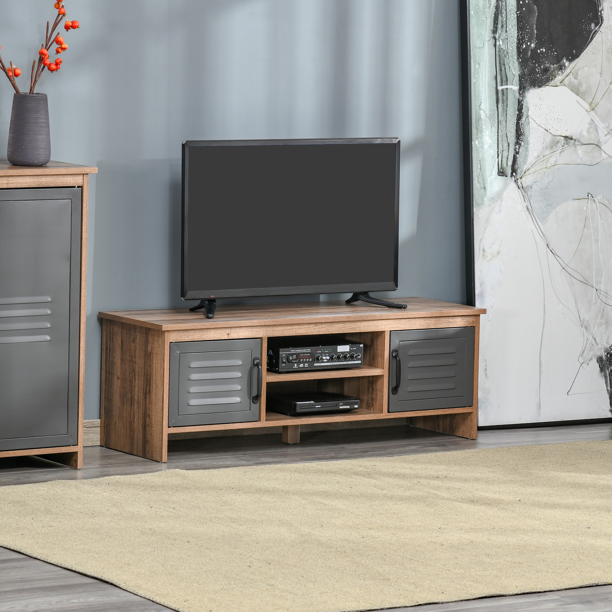 Un mueble de TV de madera con puertas de metal, un televisor encima y un jarrón al lado.