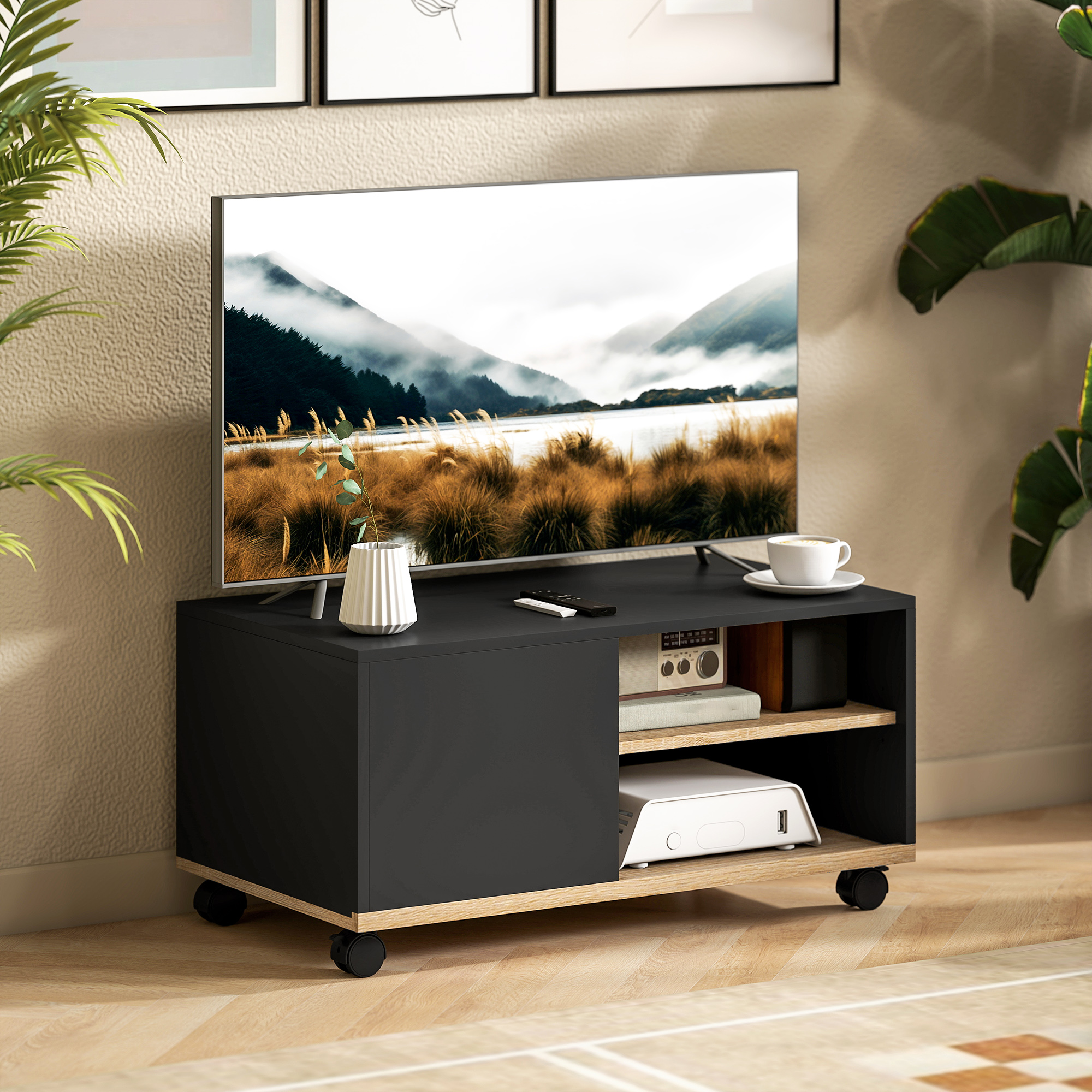 Un mueble de TV negro moderno que muestra un televisor con un paisaje de montaña.