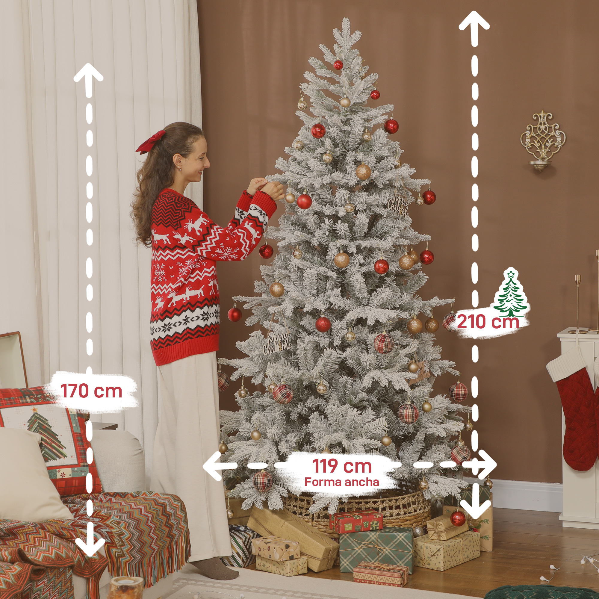 Una mujer decora un árbol de Navidad blanco con adornos rojos y dorados.