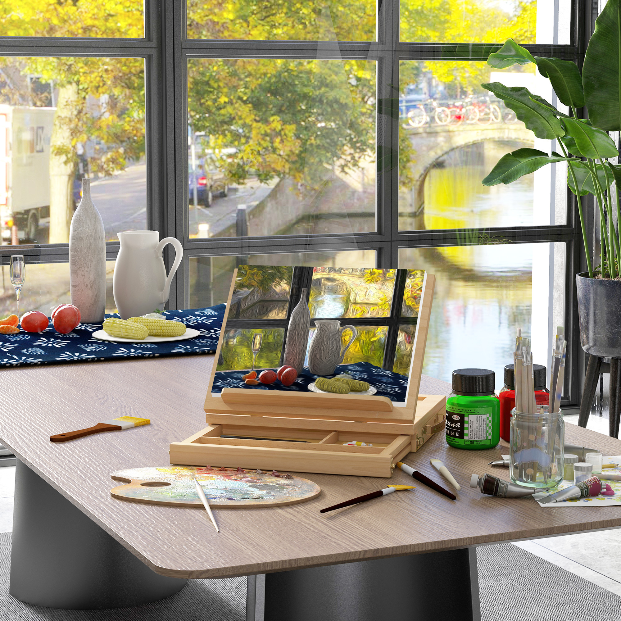 Una mesa de cocina con material de arte, con vistas a un canal con árboles.